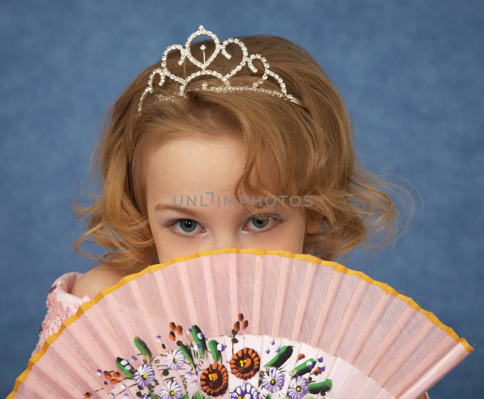 Portrait of a young girl with an Oriental fan in the hands