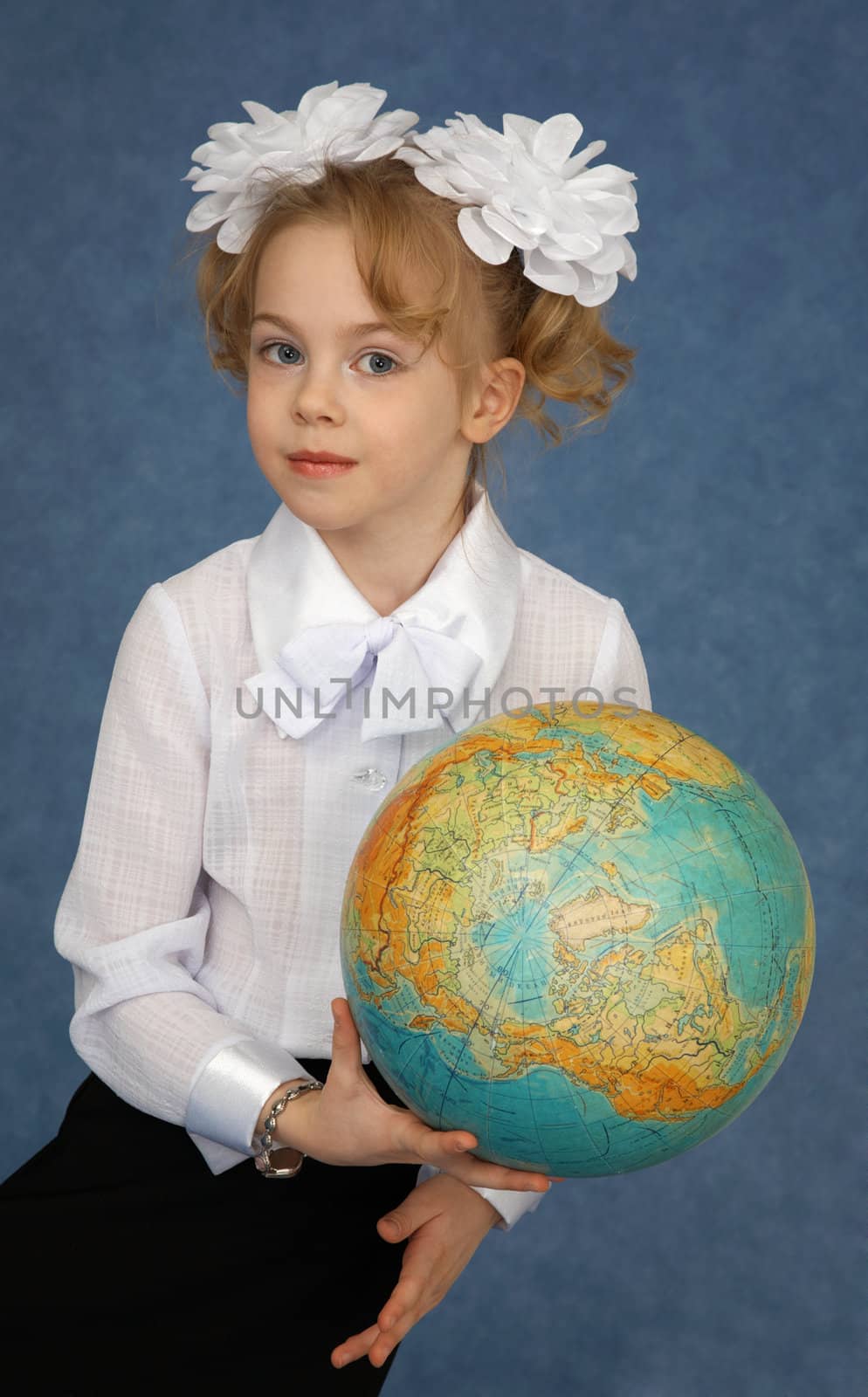 Schoolgirl with a geographic globe in hands