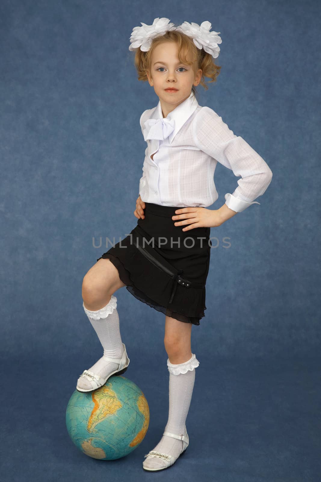 Schoolgirl put foot on the terrestrial globe