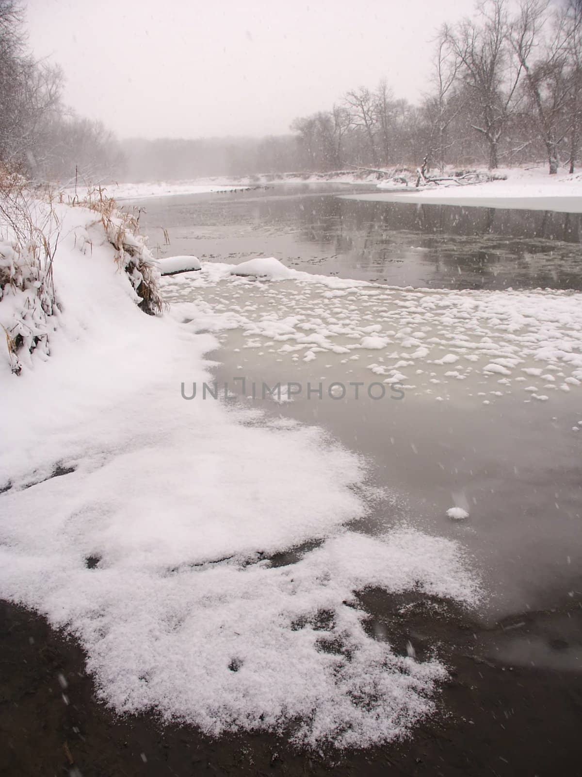 Snow falls along the Kishwaukee River on a cold winter morning at Blackhawk Springs Forest Preserve in northern Illinois.