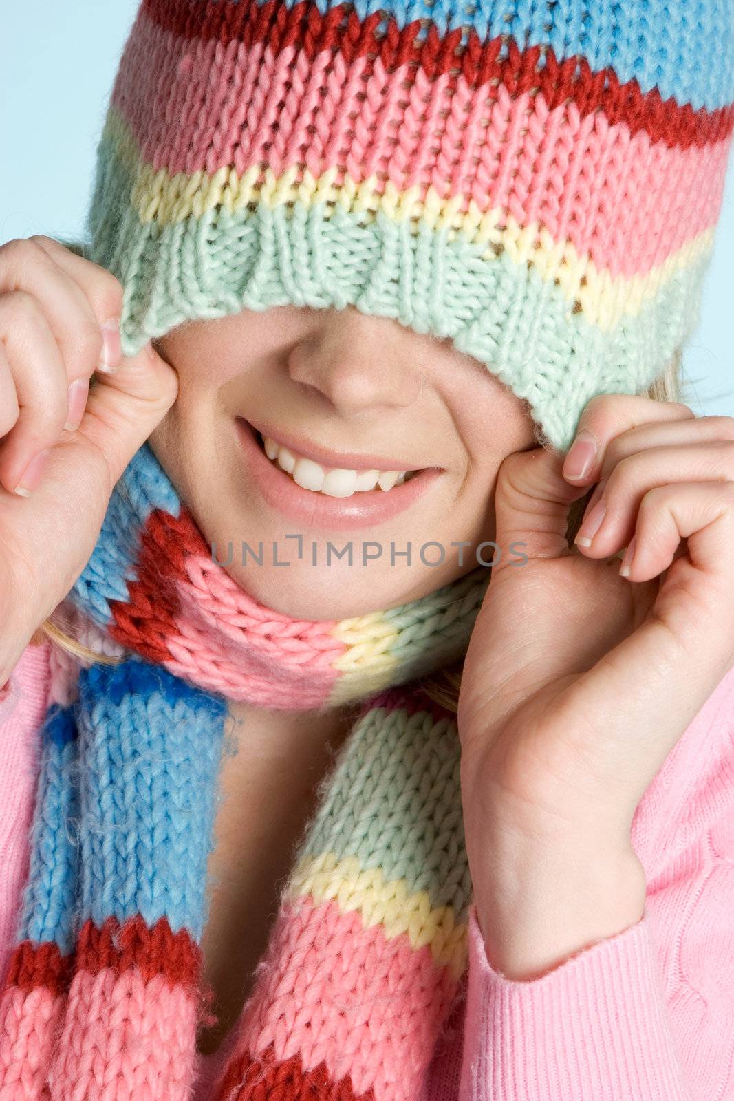 Playful smiling winter hat girl