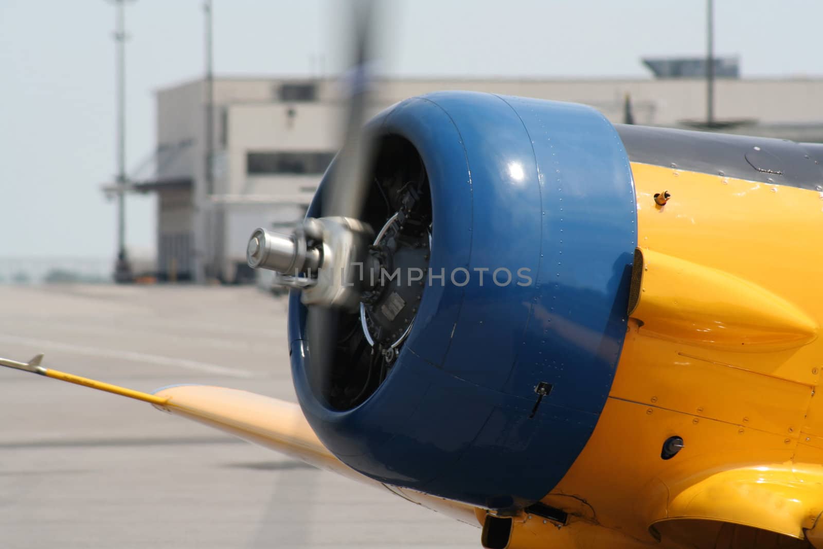 The spinning propeller of an old plane at an airshow.
