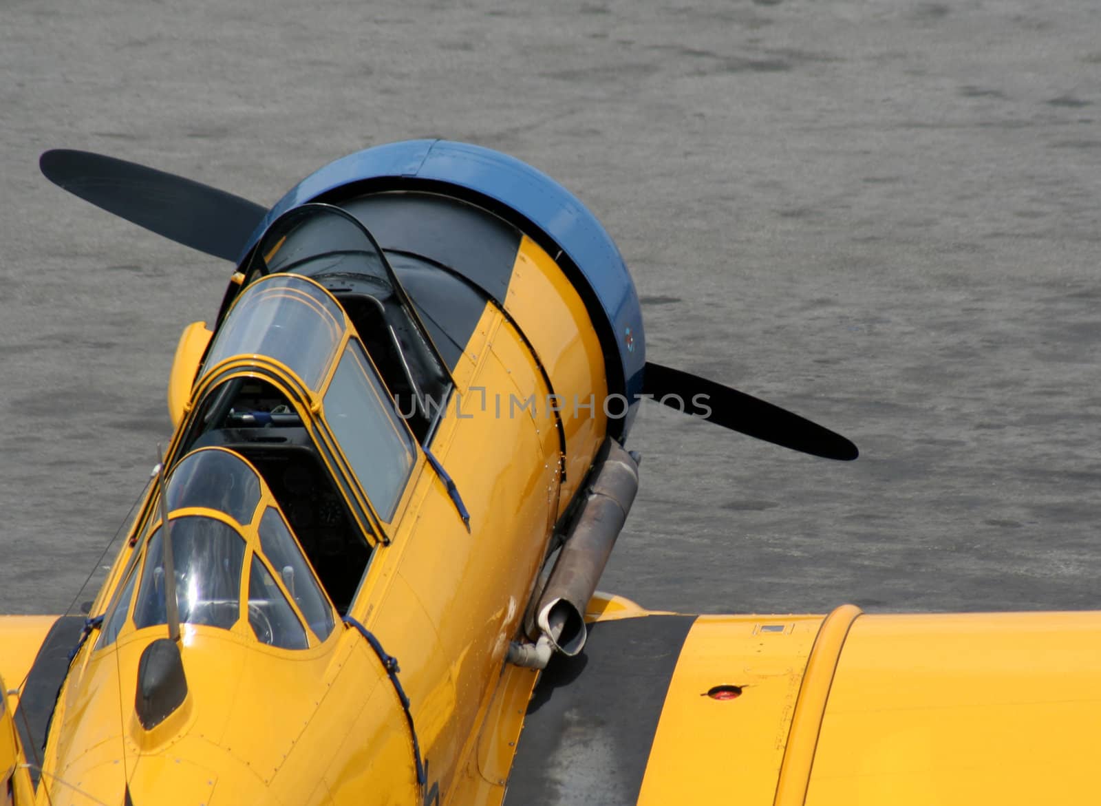 A yellow antique fighter plane.
