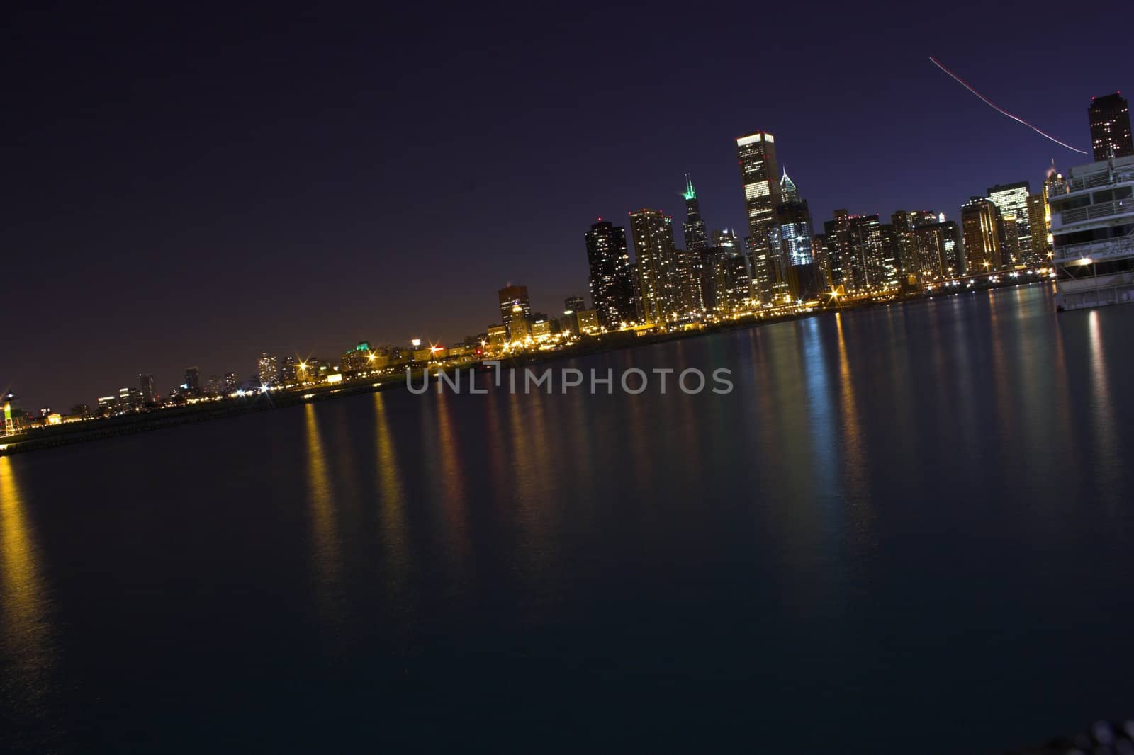 View of city Chicago from the water during sunset and at night