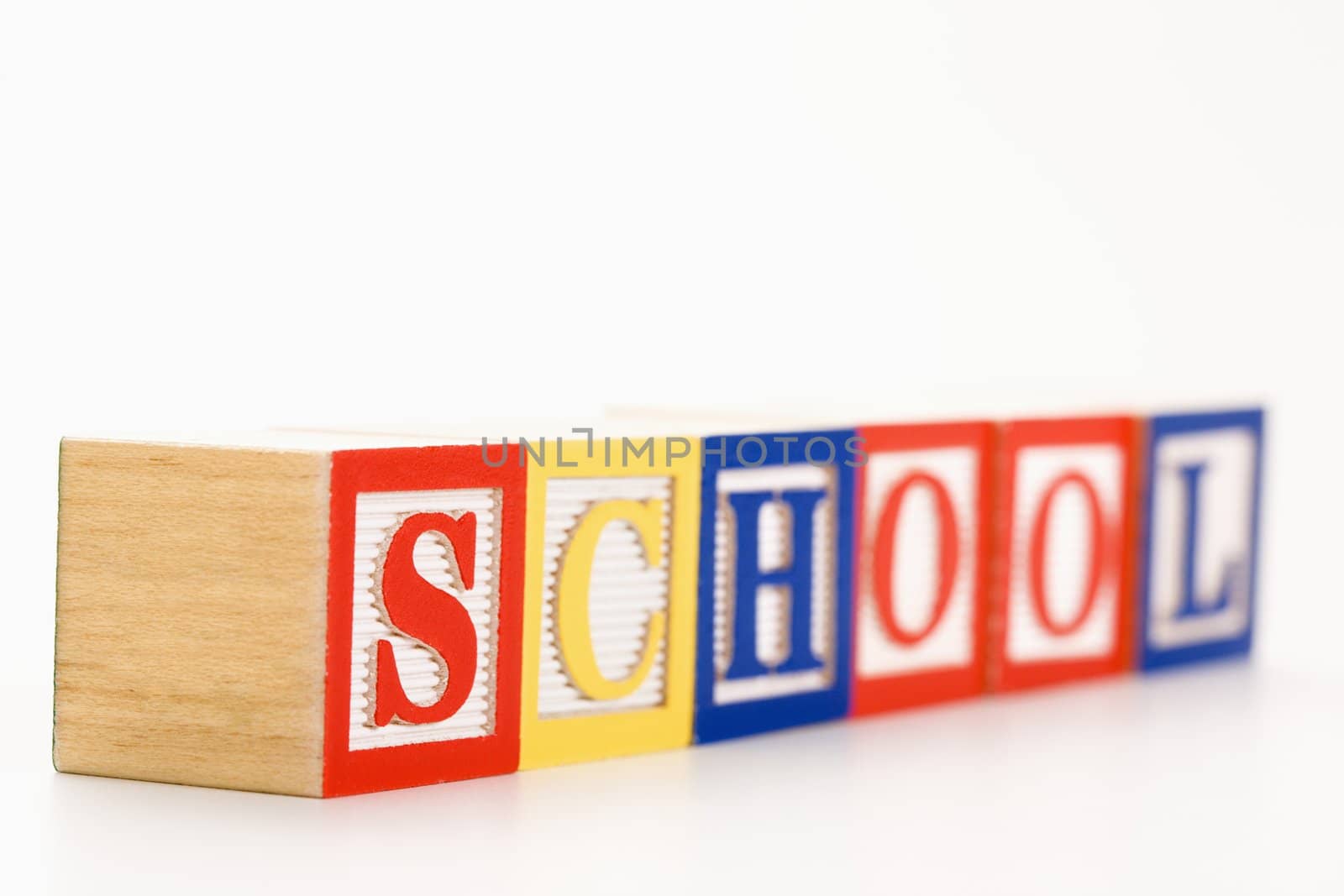 Alphabet toy building blocks spelling the word school.