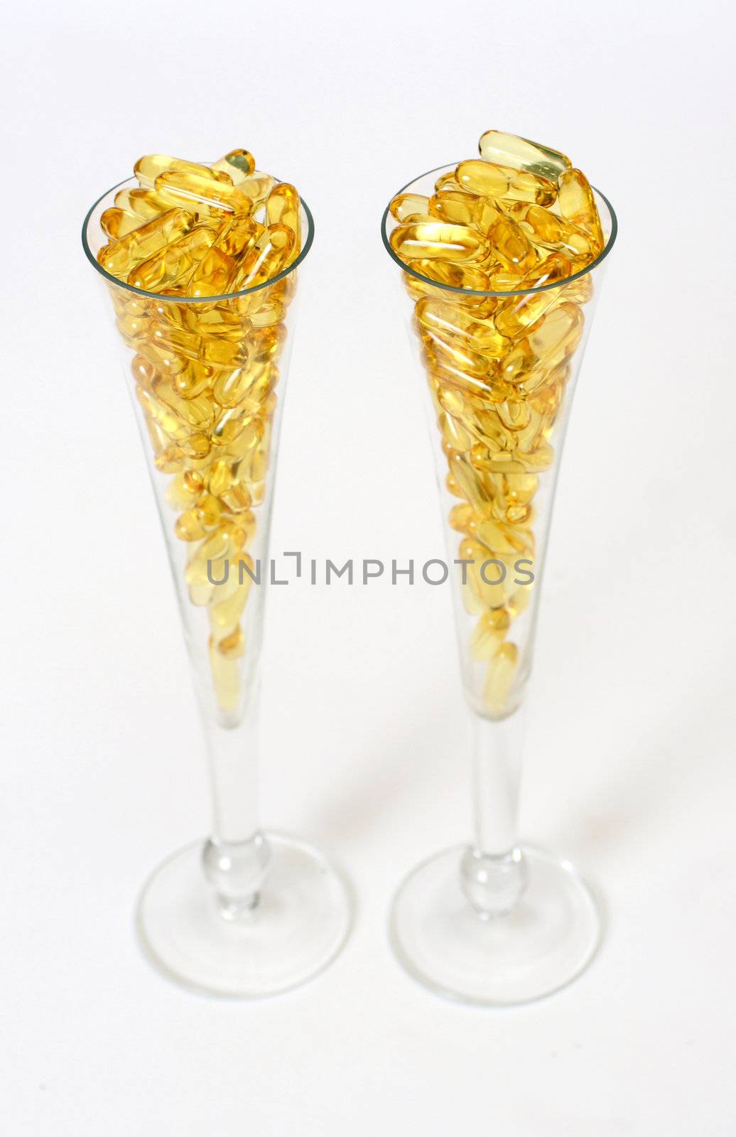 Two glasses with gold shiny boluses