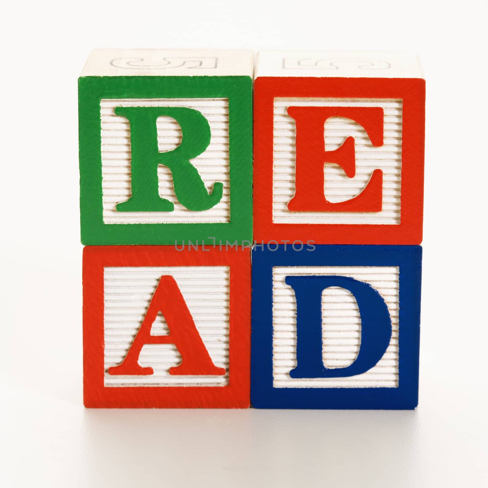 Stack of alphabet toy building blocks spelling the word read.