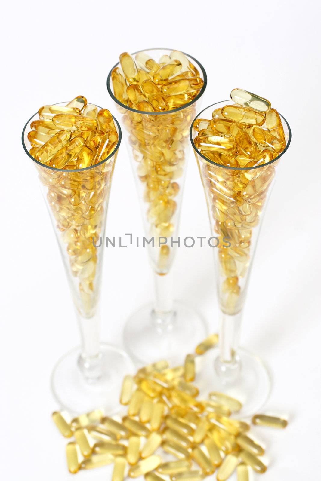 Three glasses with gold shiny boluses