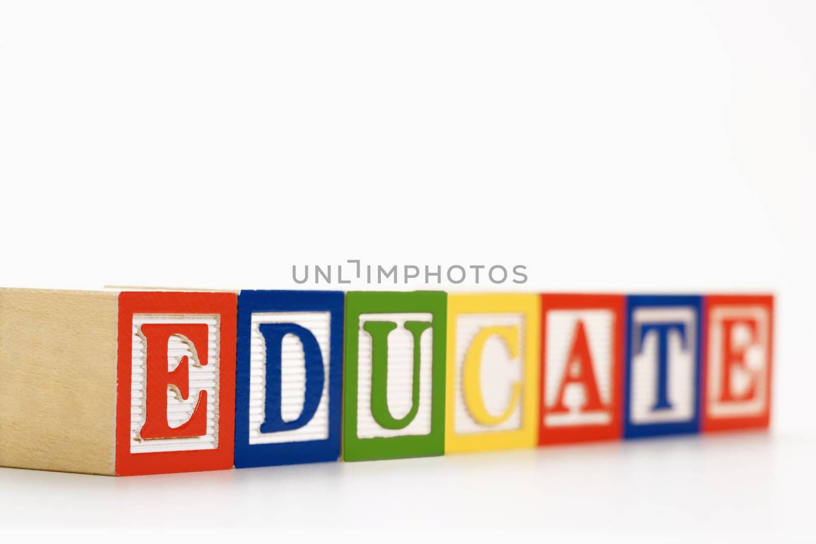 Alphabet toy building blocks spelling the word educate.