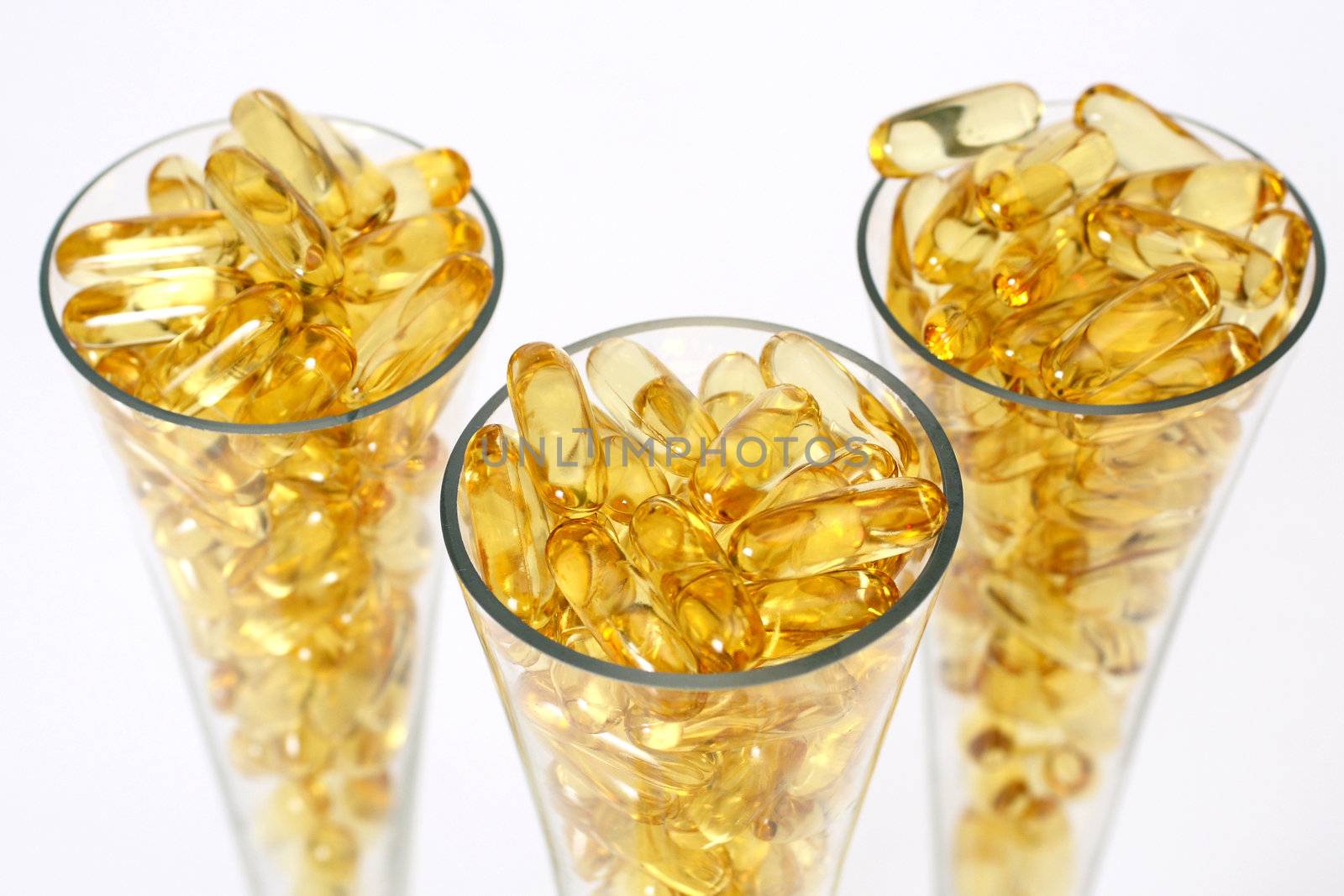 Three glasses with gold shiny boluses