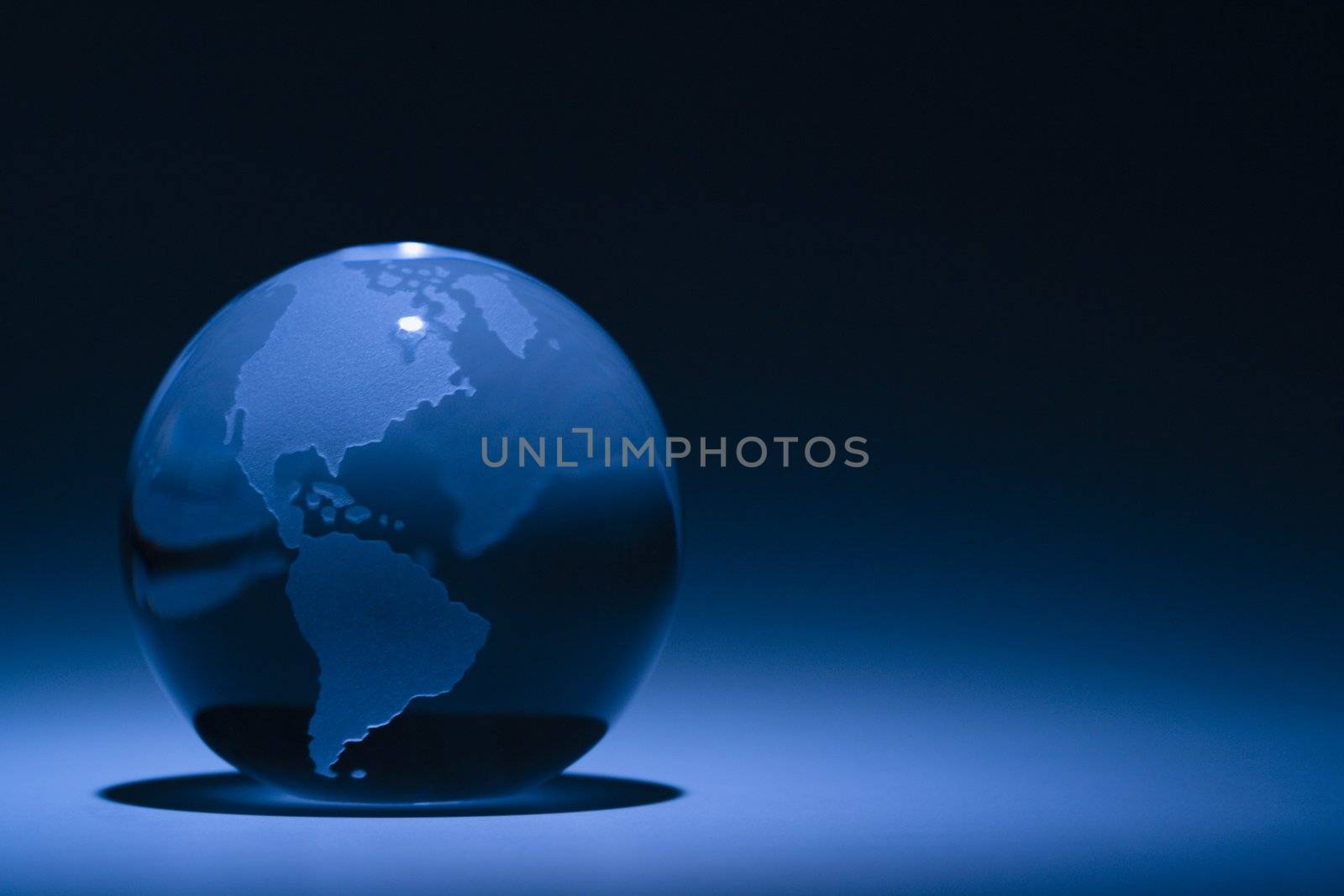 Blue still life of globe showing South America and North America.
