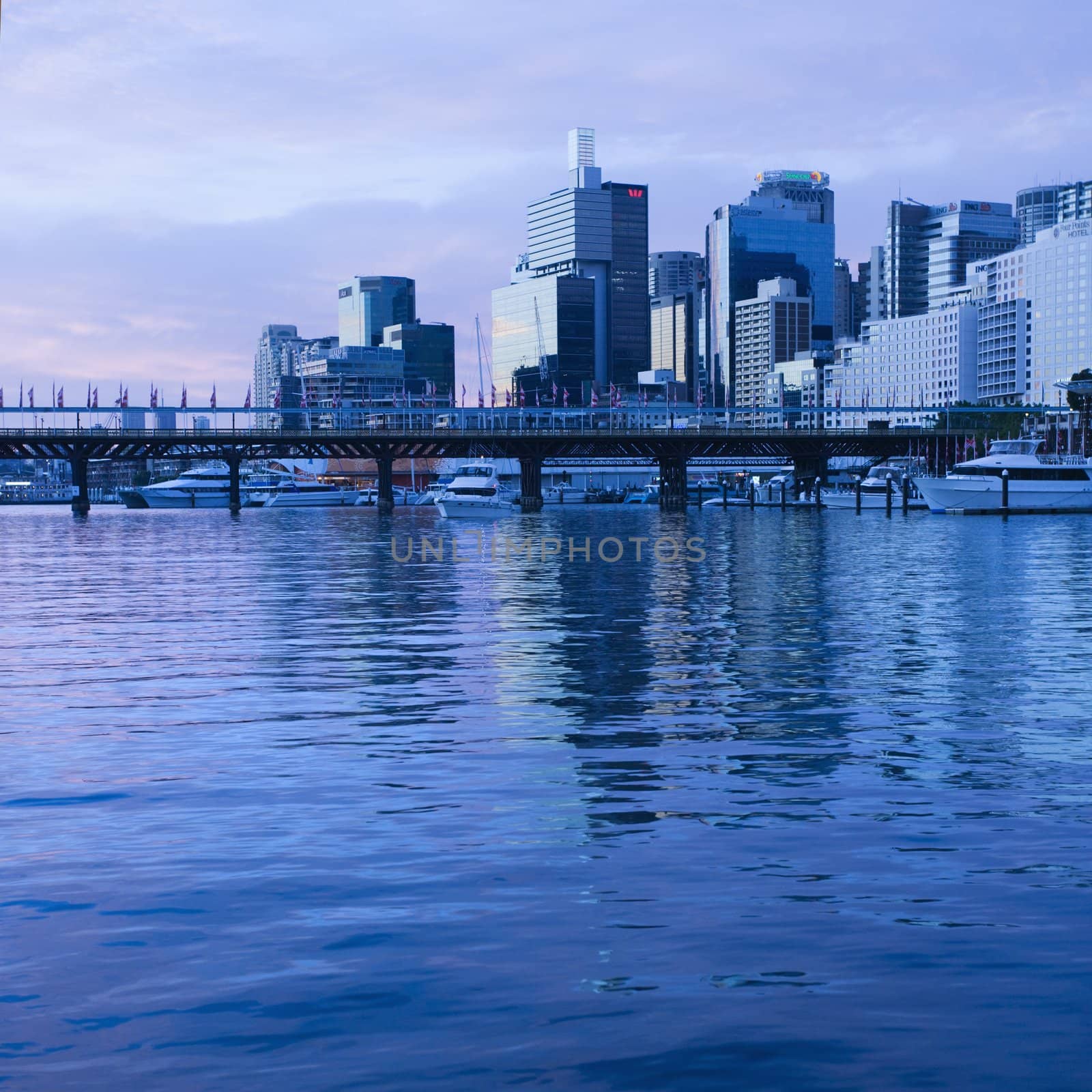 Pyrmont Bridge over Darling Harbour with skyscrapers in Sydney, Australia.