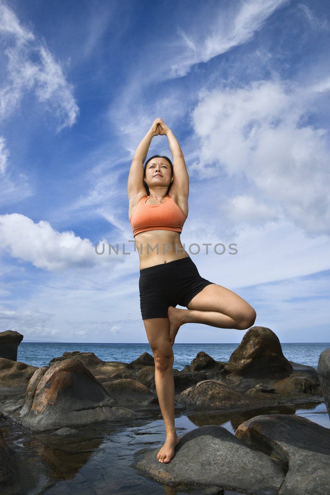 Woman in tree pose by iofoto