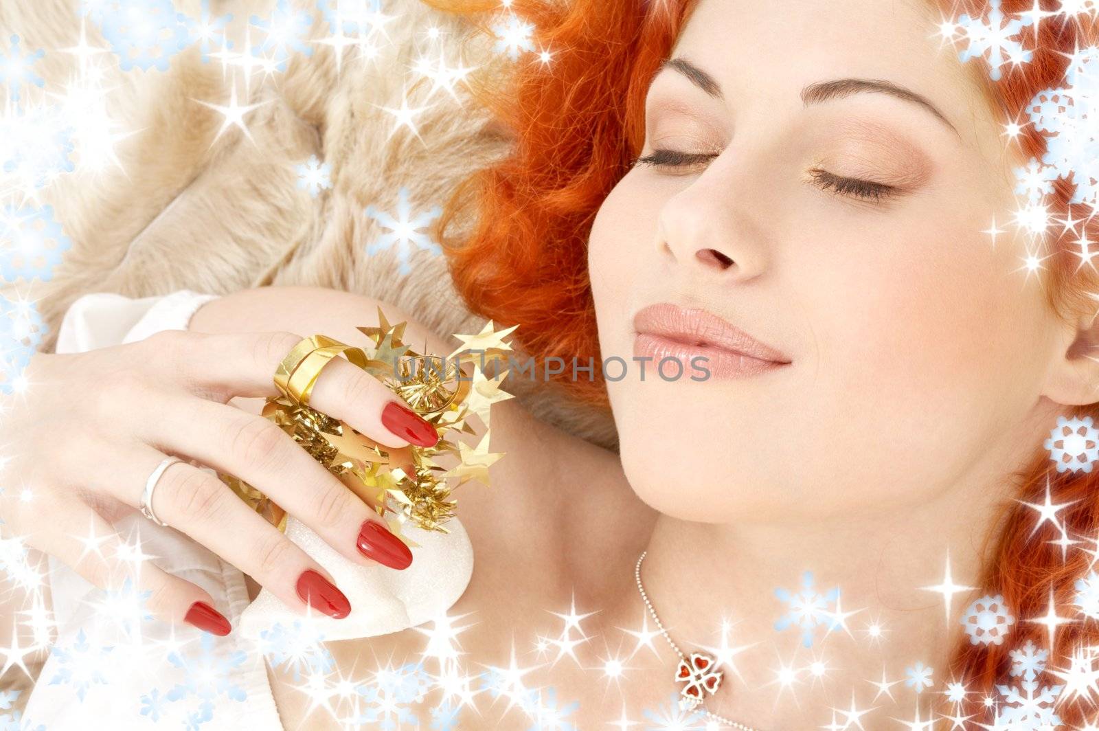 dreaming redhead girl with white christmas bells and snowflakes