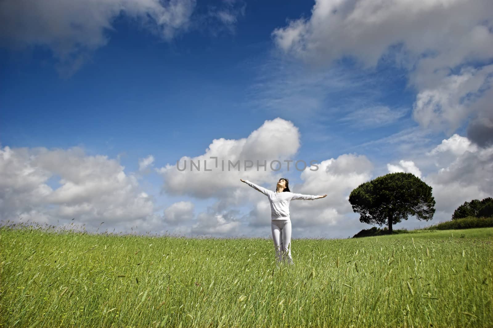 Woman relaxing on a beautiful green meadow