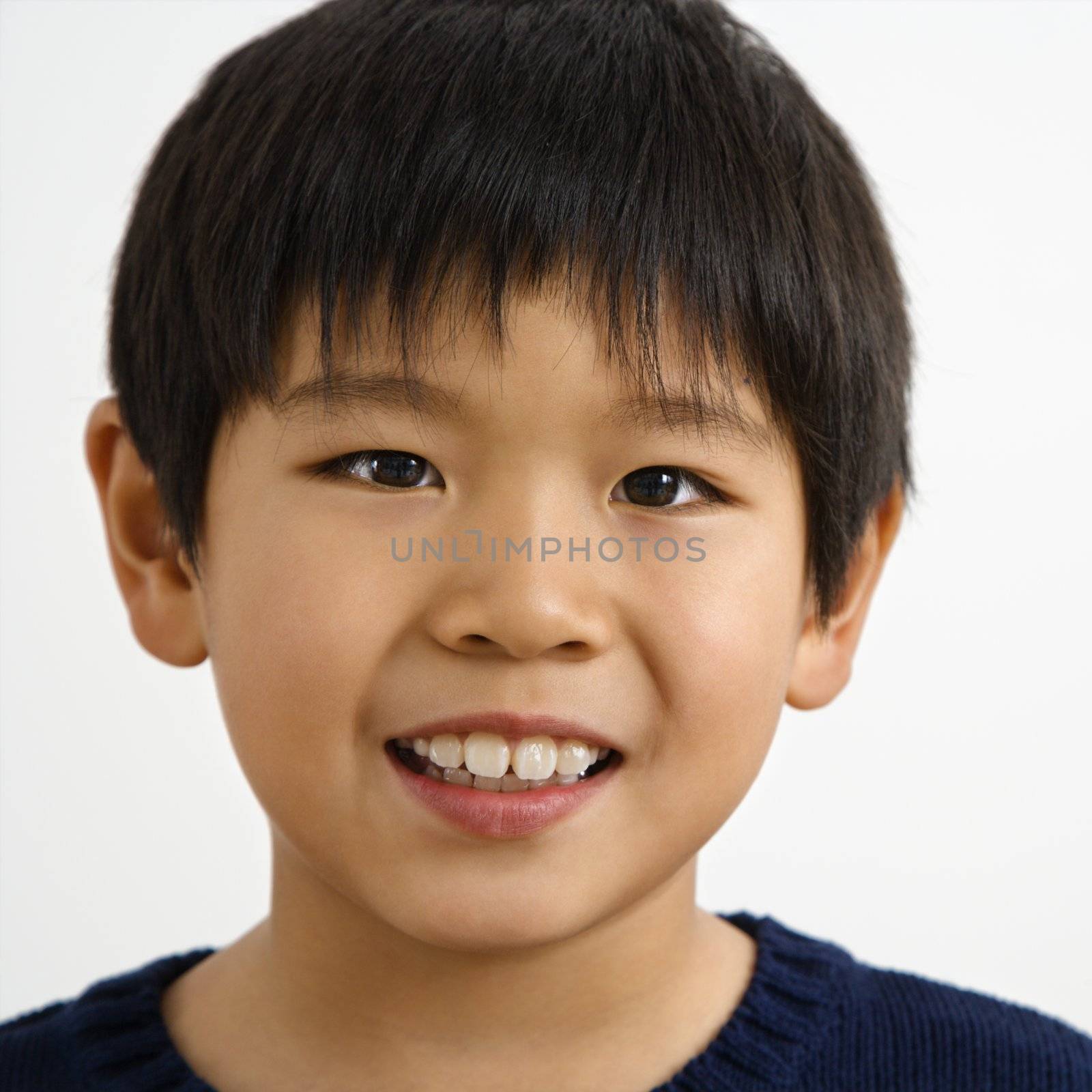 Portrait of young Asian boy smiling.