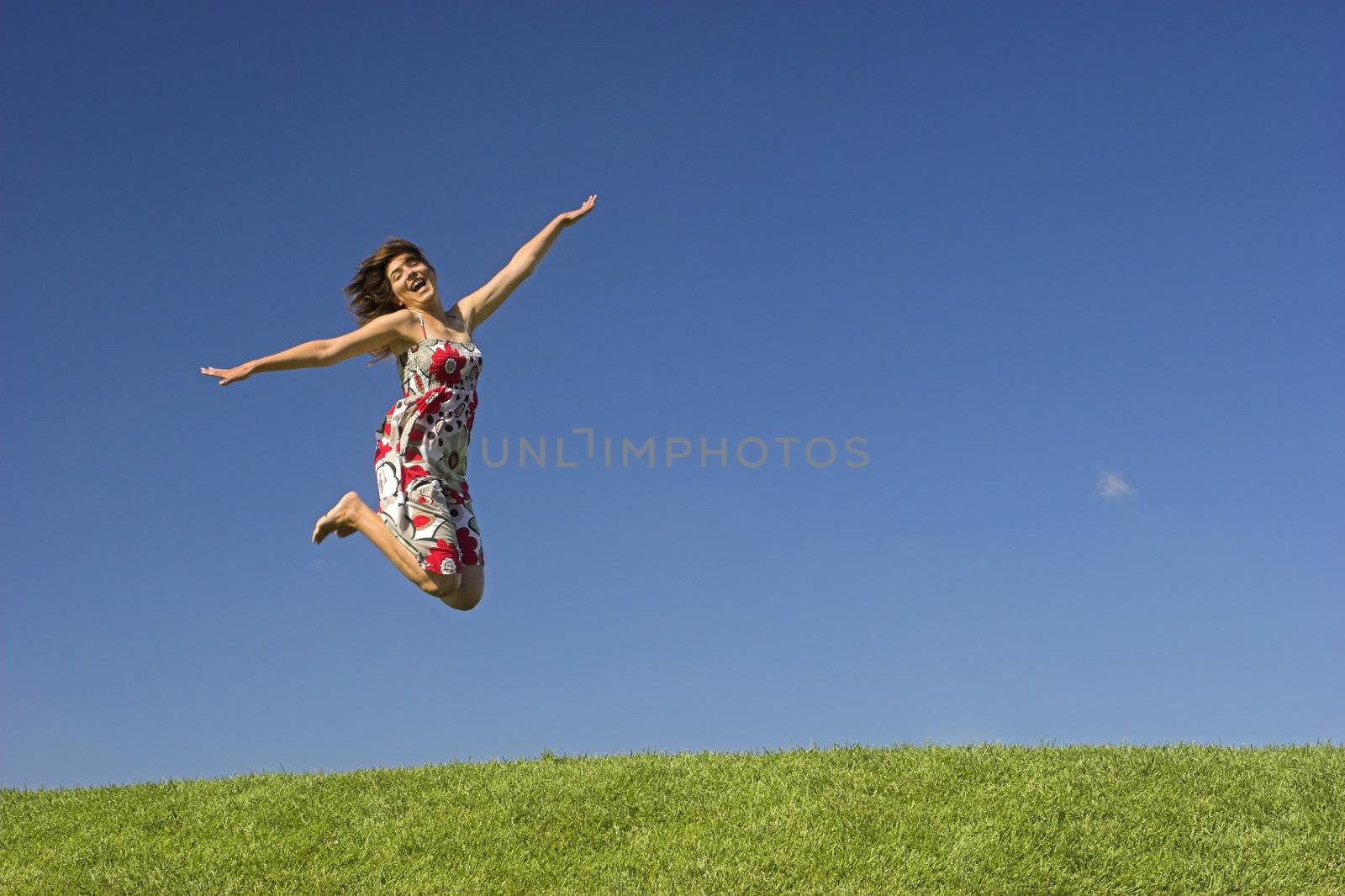 Happy woman on a beautiful green meadow