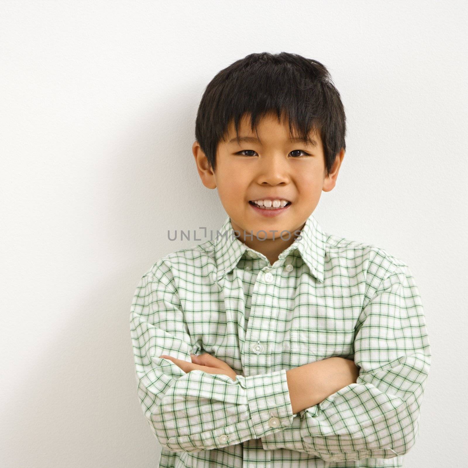 Portrait of young Asian boy smiling.