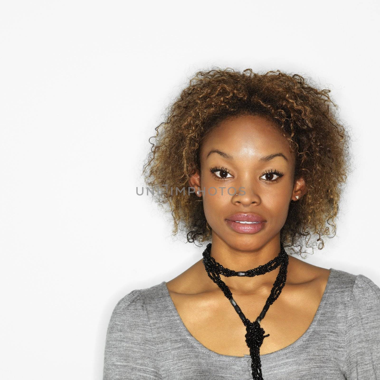 Portrait of pretty young woman on white background.