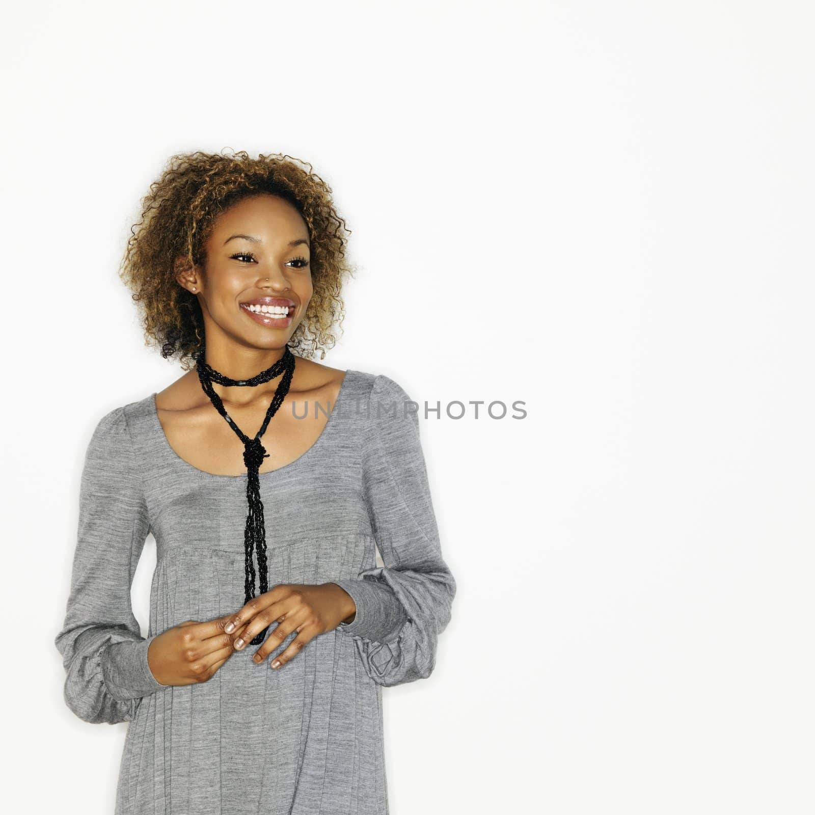 Portrait of pretty young woman smiling on white background.