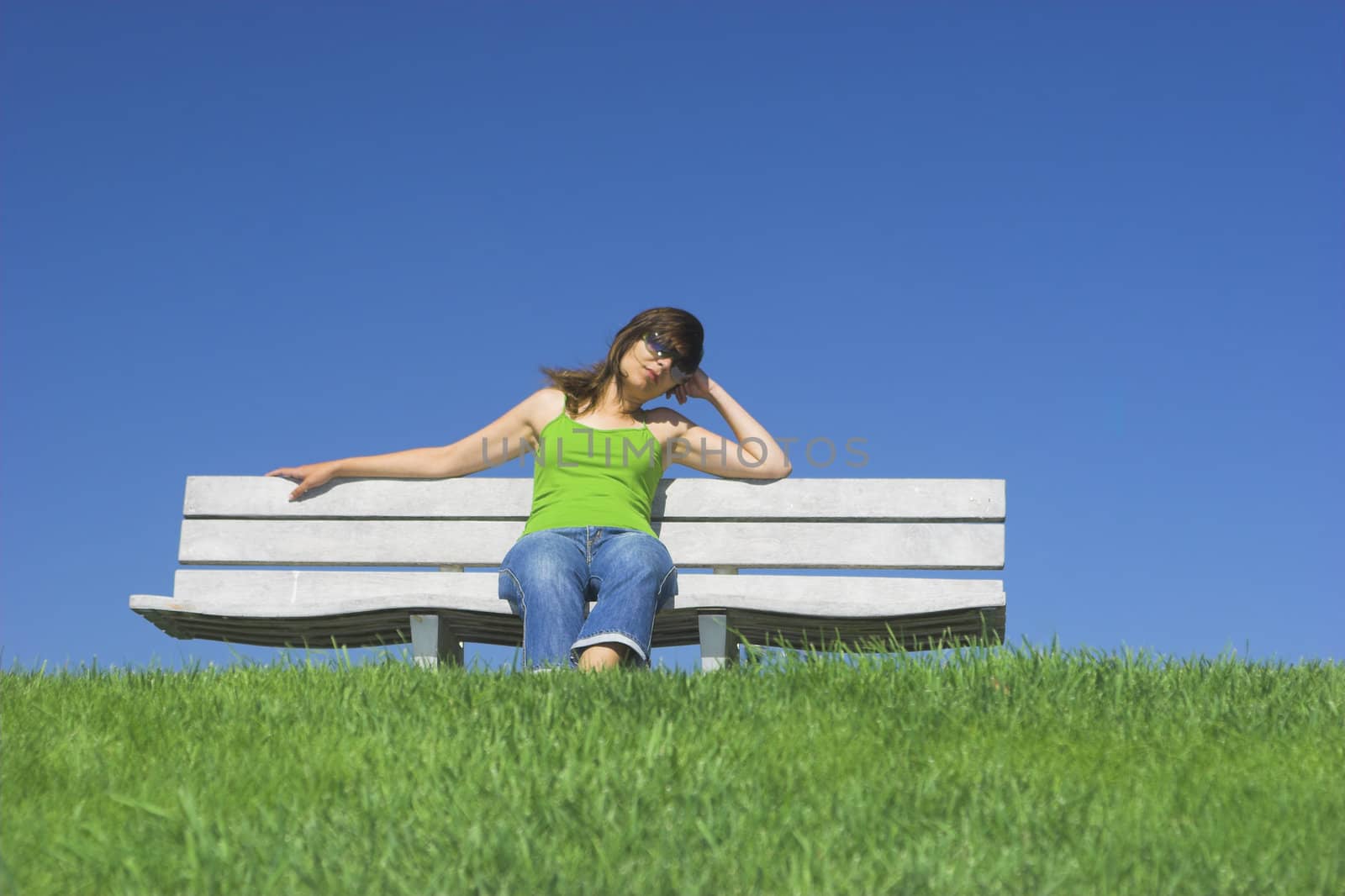 Beautiful woman relaxing on a beautiful green field