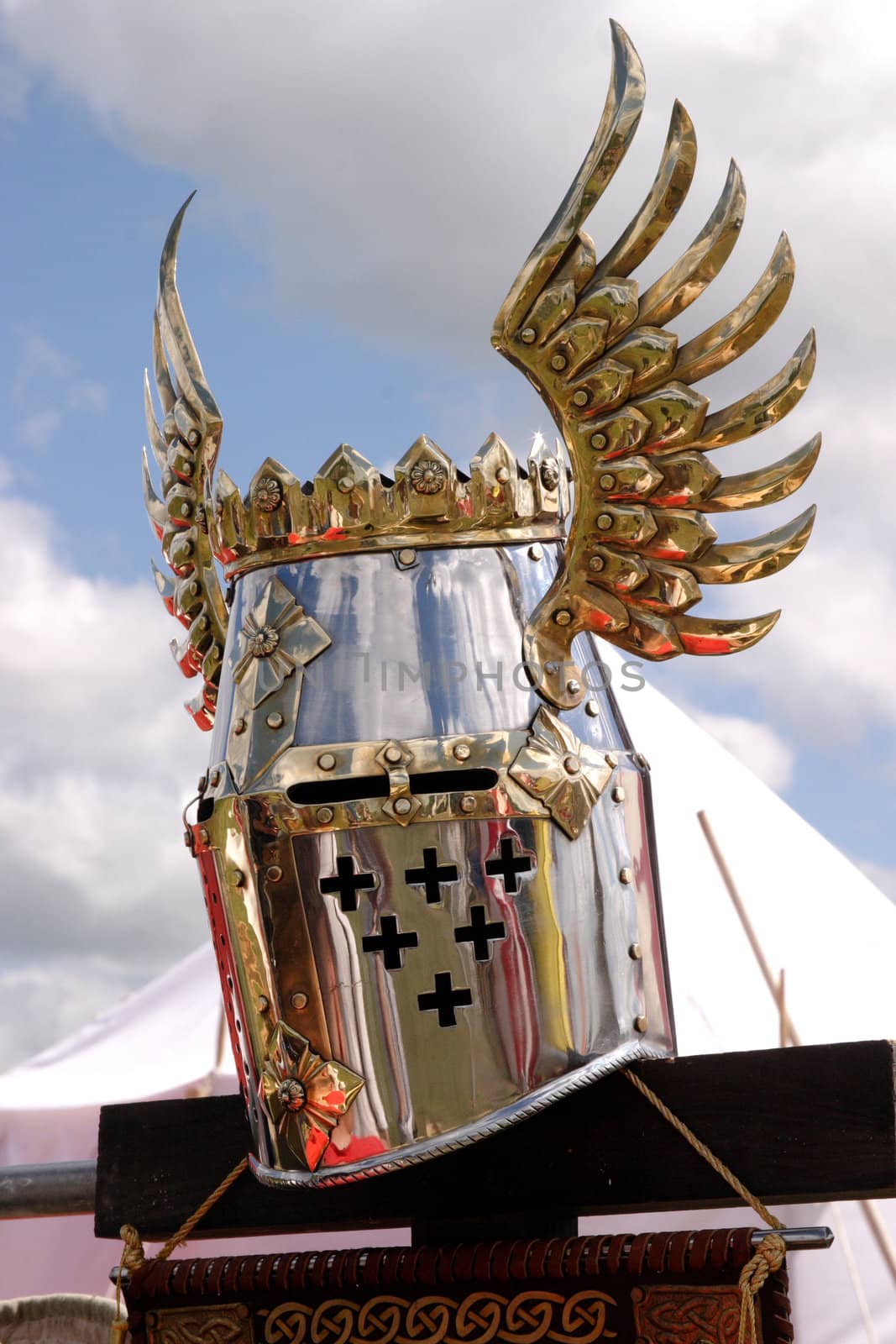 Knightly helmet on a background of the sky