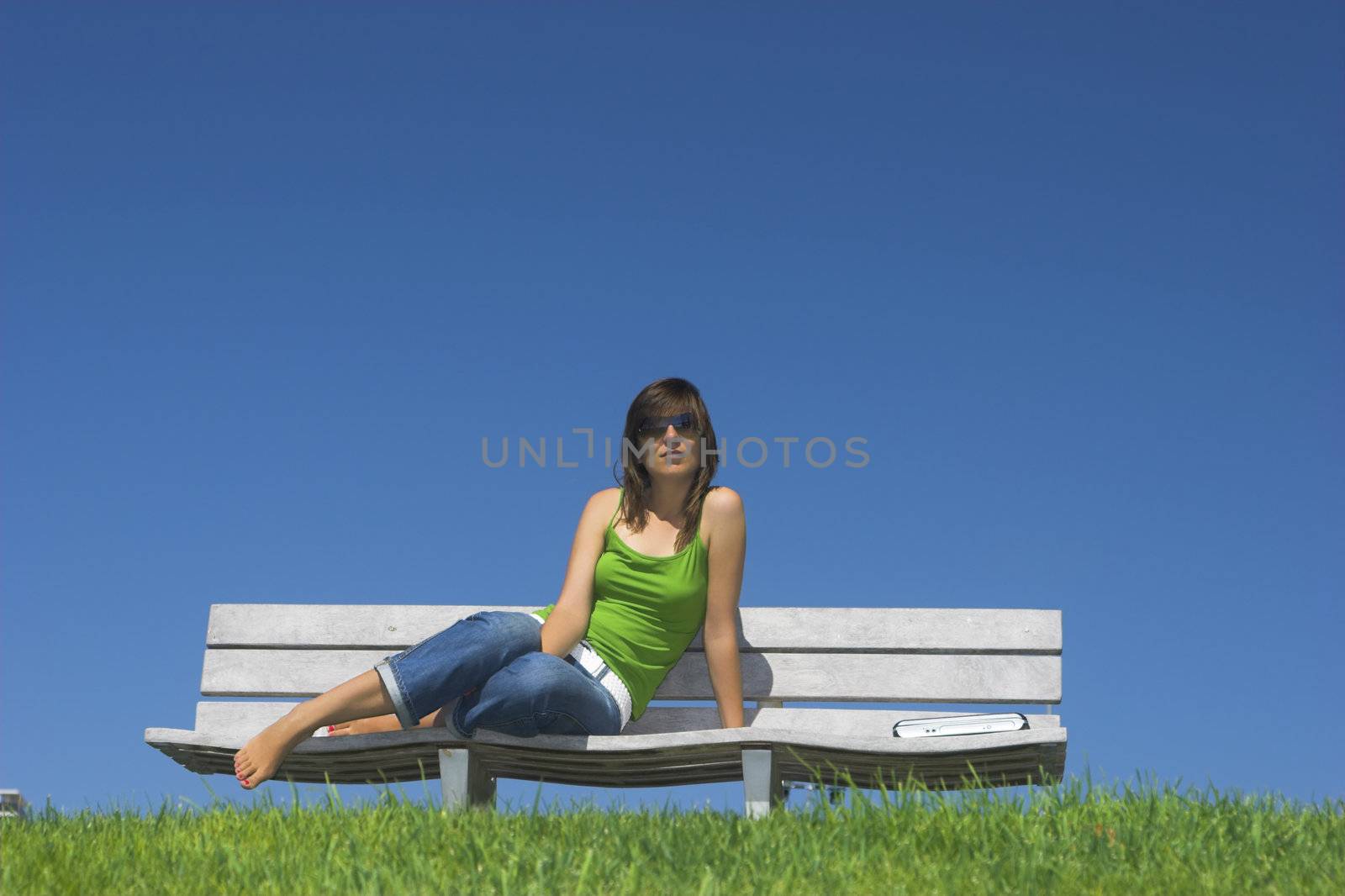 Beautiful woman on a chair relaxing in beautiful sunny day
