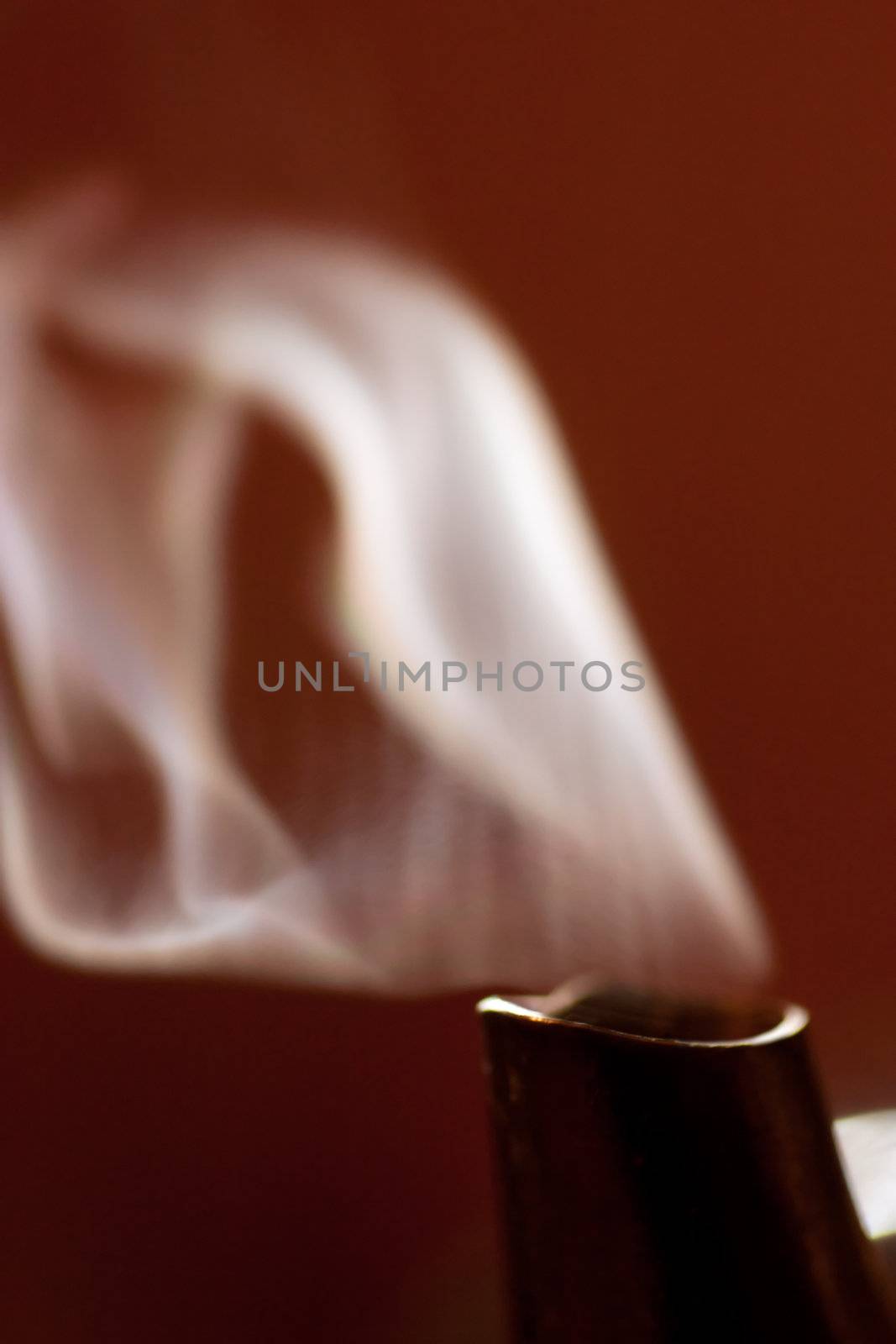 Macro view of steam from a spout of a teapot.