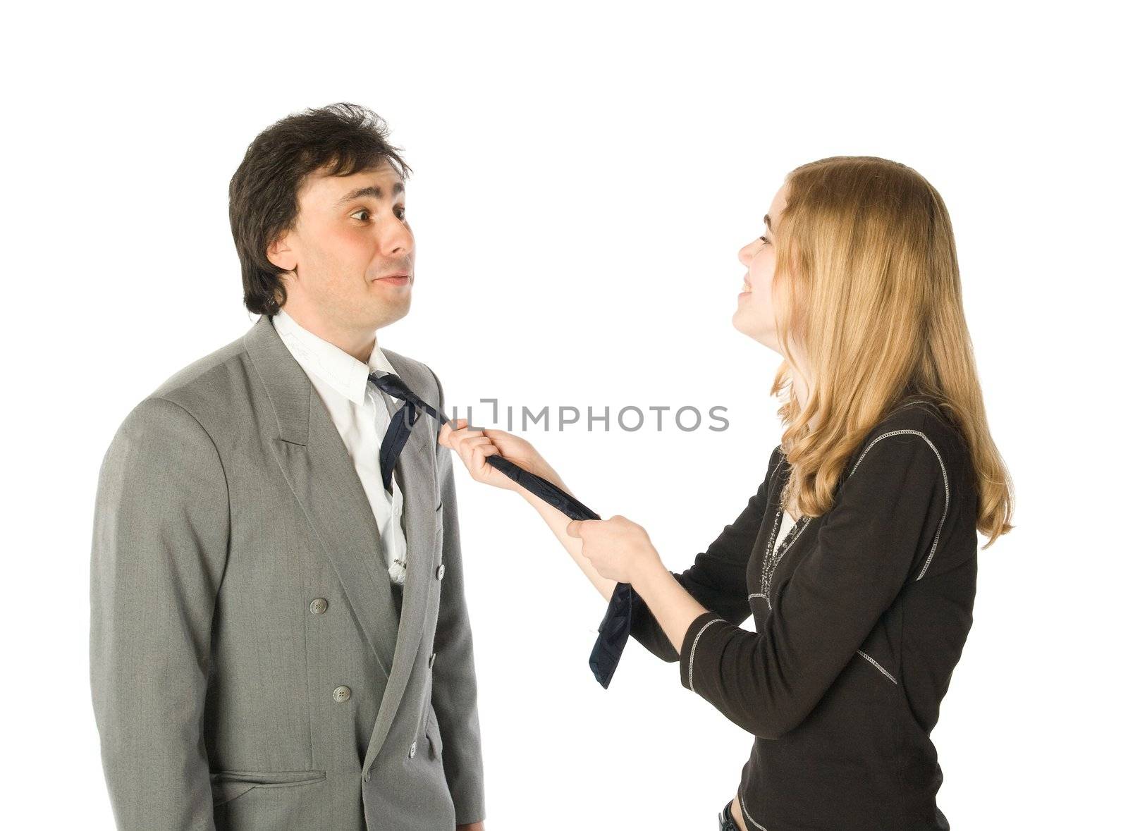 Young pretty woman pulling a man by a necktie