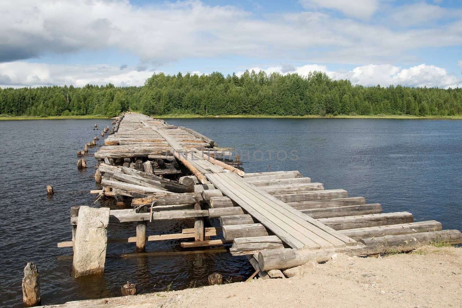 An old broken bridge on a river in Karelia, Russia 