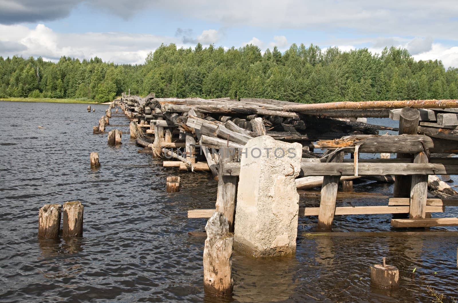 An old broken bridge on a river in Karelia, Russia 