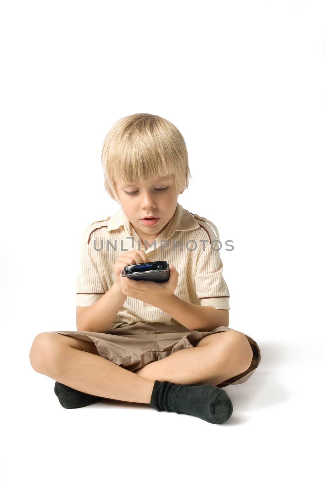 Little boy playing with PDA, studio shot