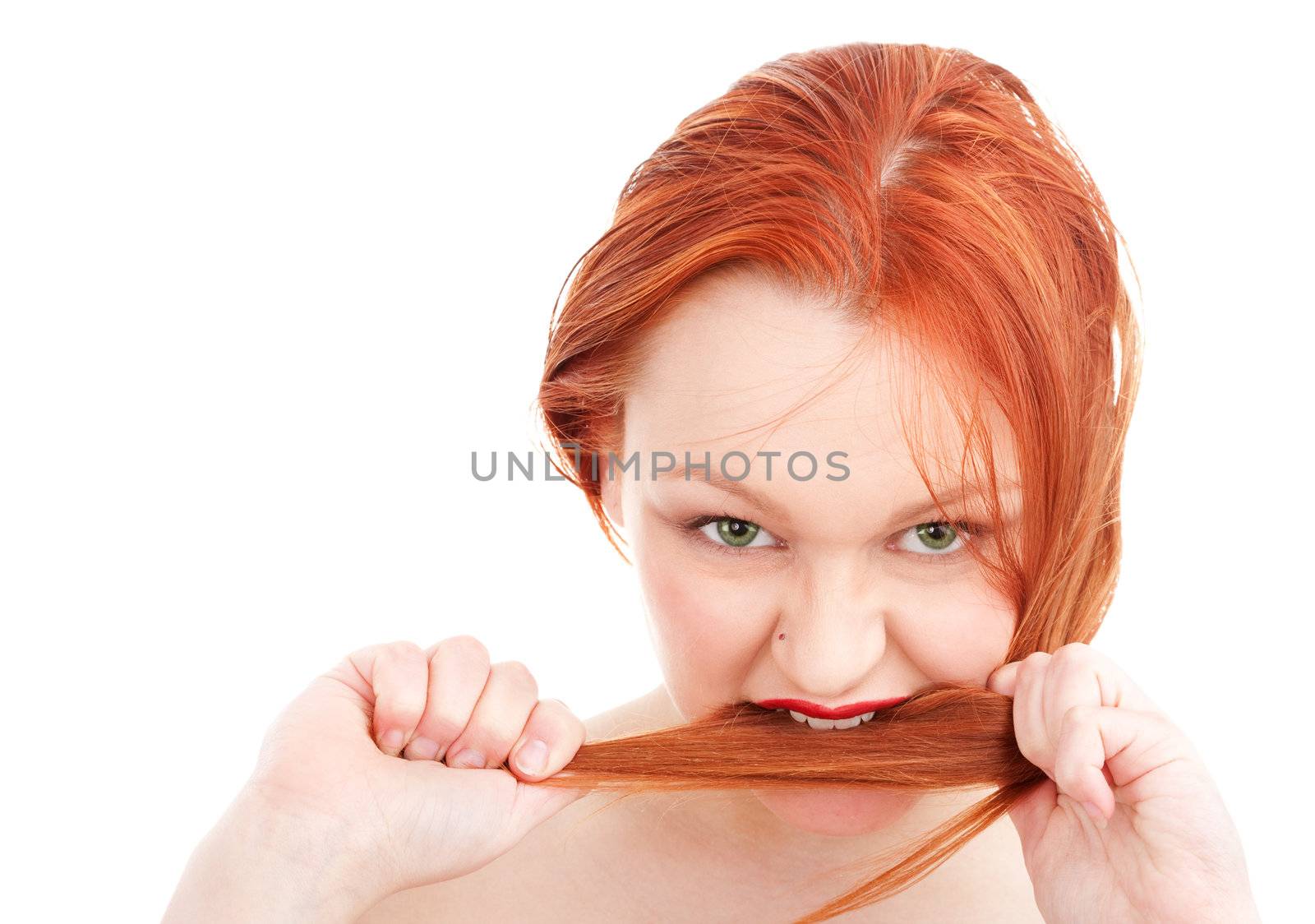 Young redhead woman biting her hair by mihhailov