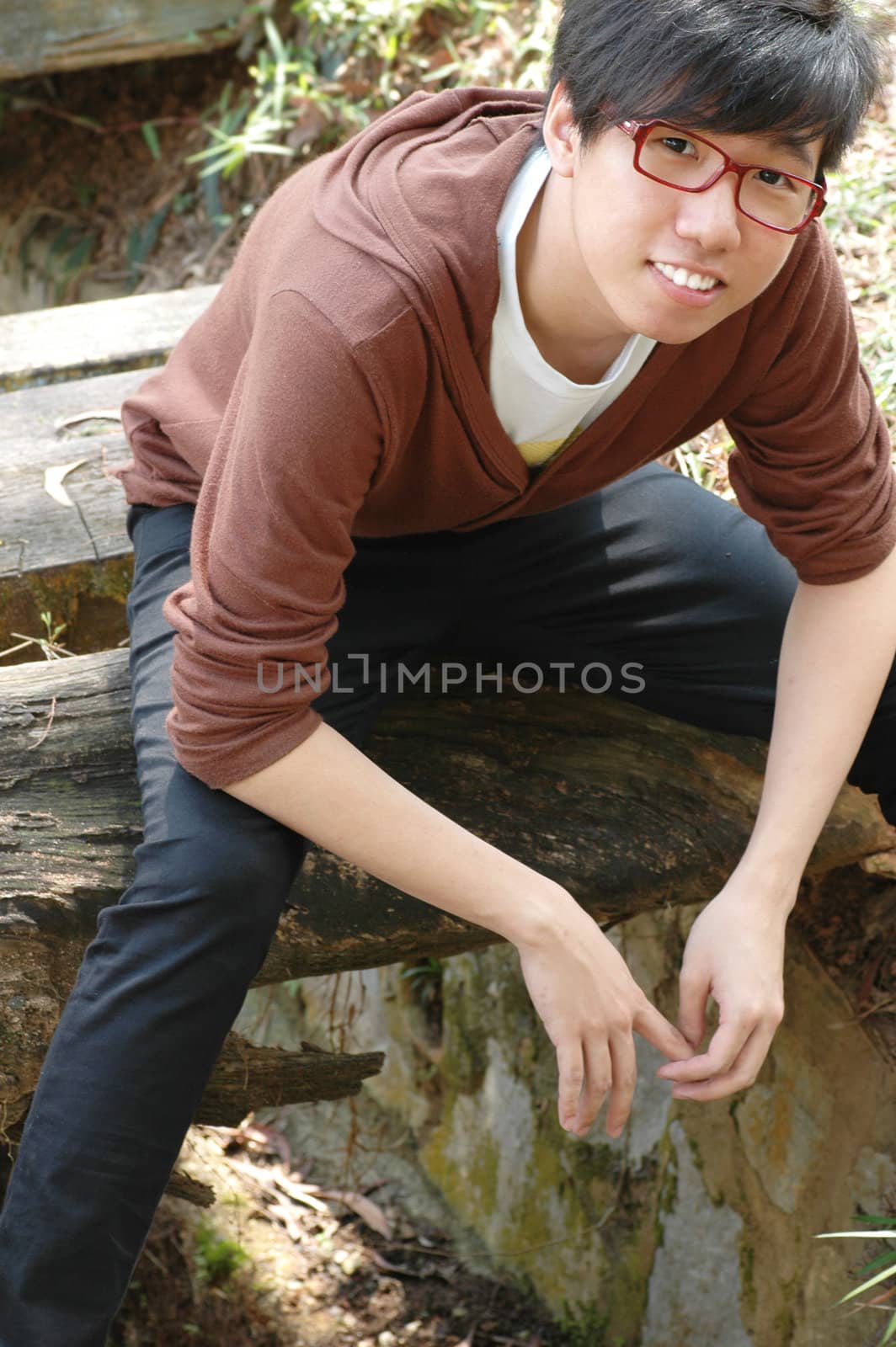 Happy young Chinese male smiling on a summer day