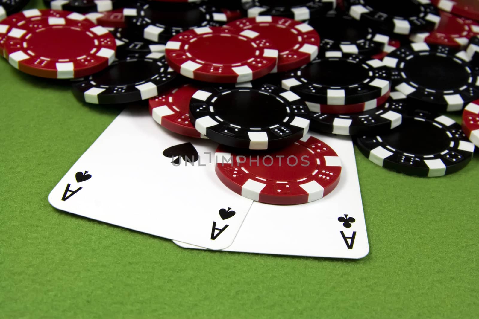 Two black aces over poker many chips