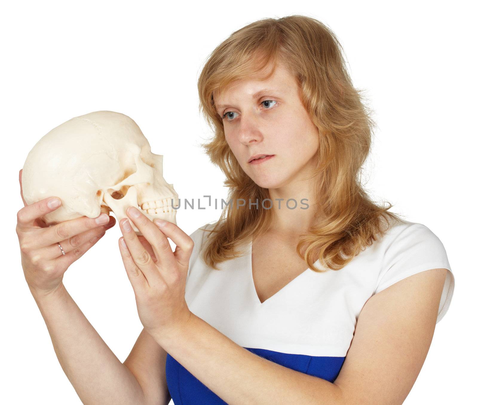 Student watches a plastic human skull isolated on a white background