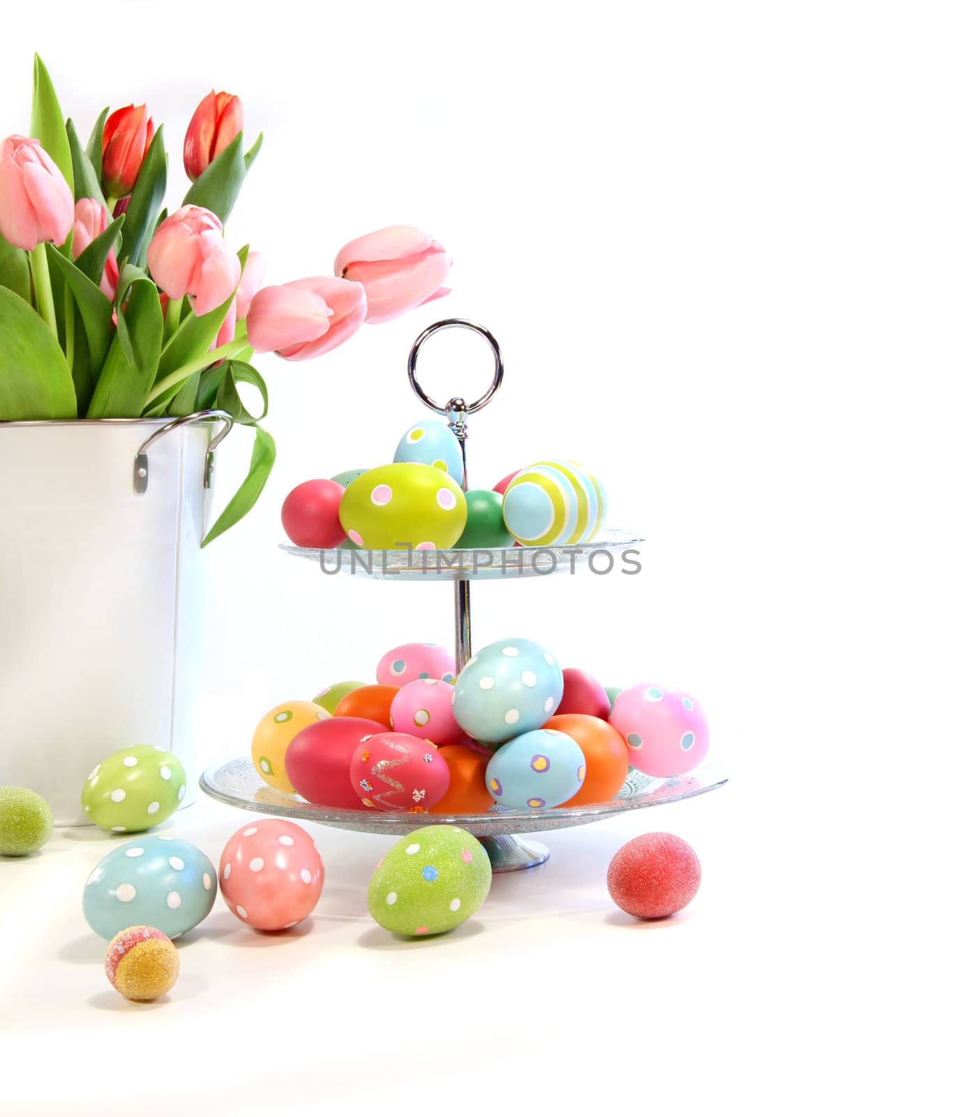 Colorful easter eggs with pink tulips on white background