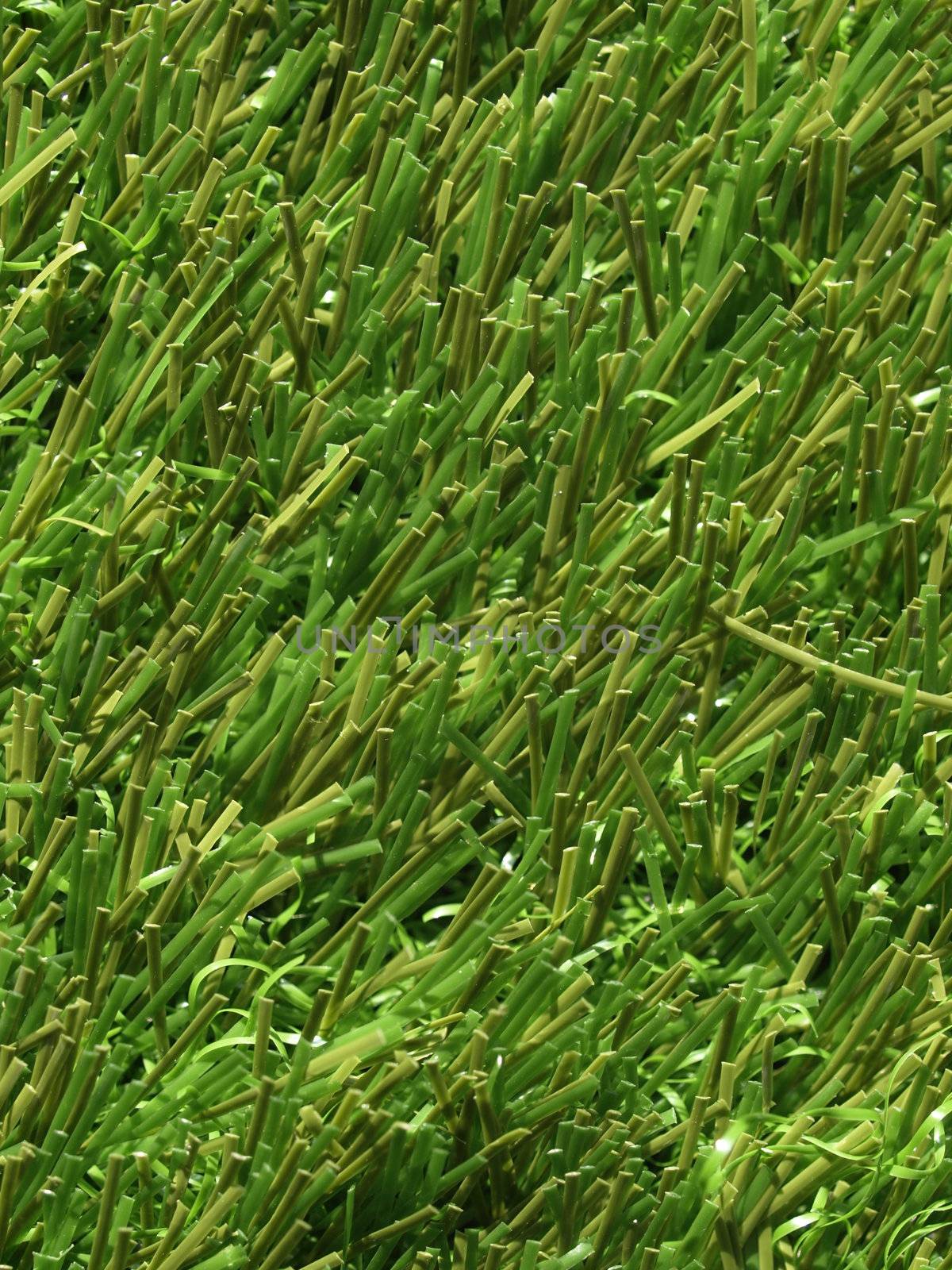 Detail of green grass artificial lawn meadow, useful as a background