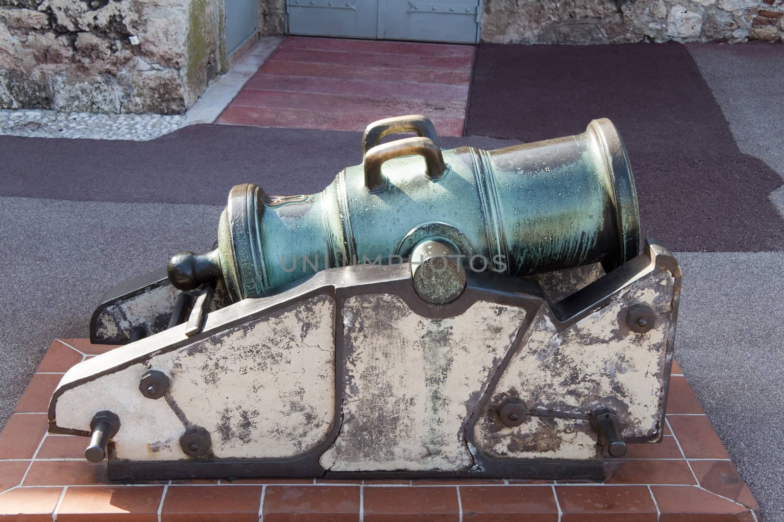 An old bronze cannon that has tarnished