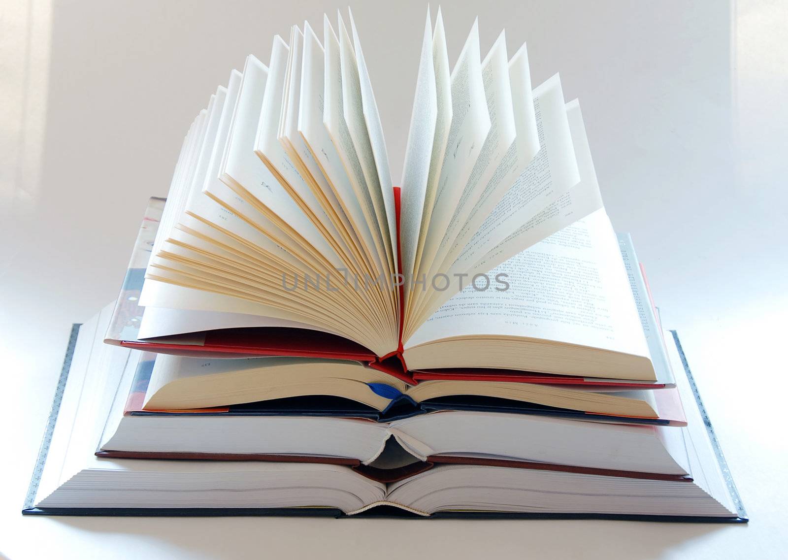 opened large book stack on white background