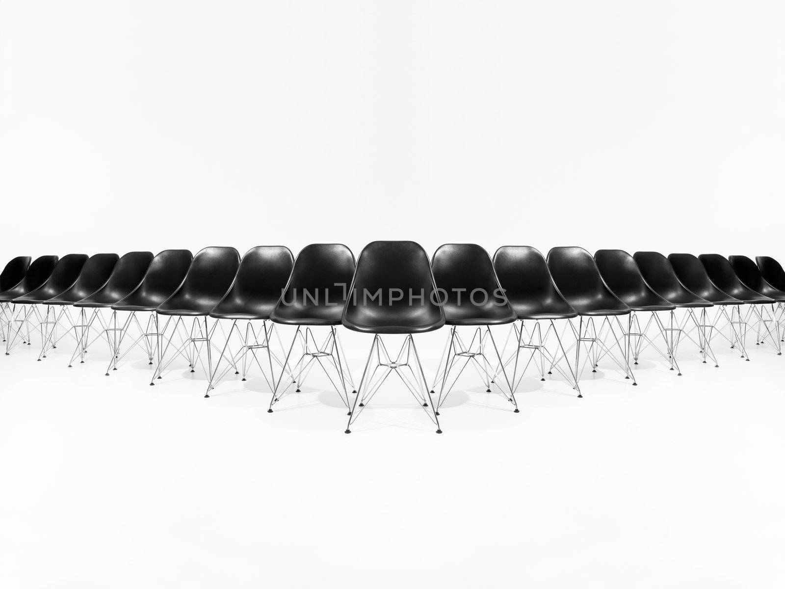 Formation of black chairs isolated on white background