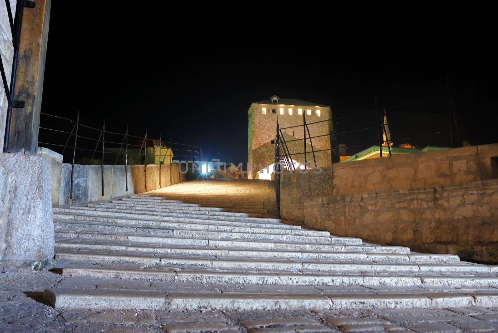 Entrance to the Old Bridge in Mostar at night reconstructed in 2003 after the original from 1556.