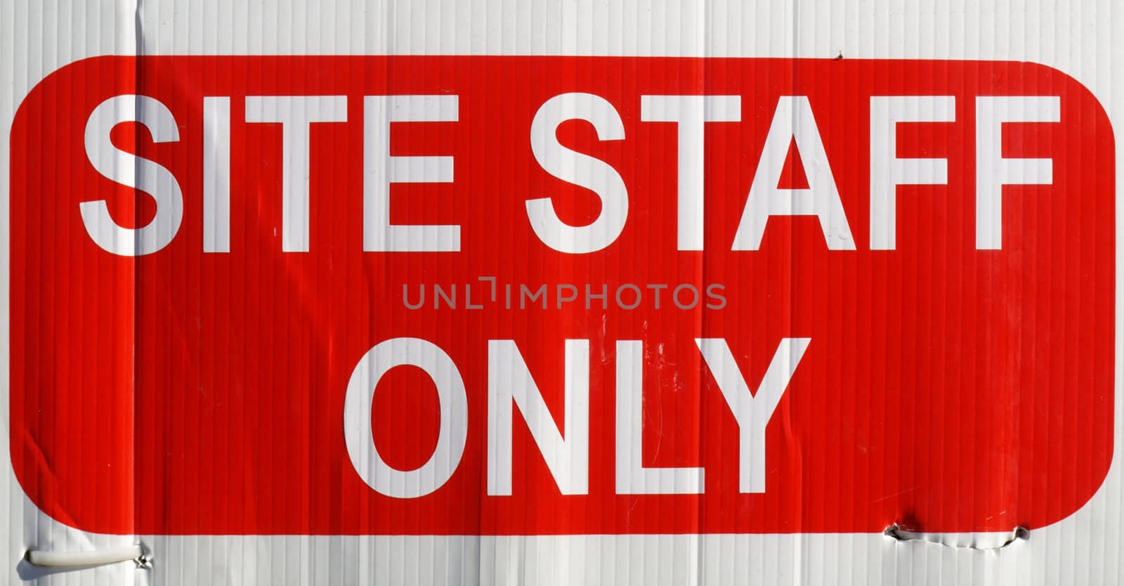 Detail of site staff only sign in white over red