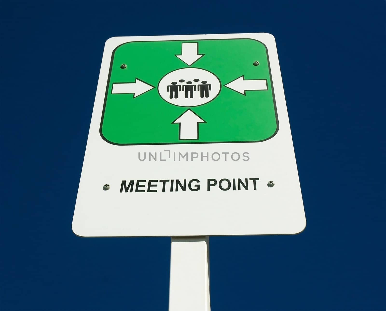 meeting point sign in a pole, against the sky.
