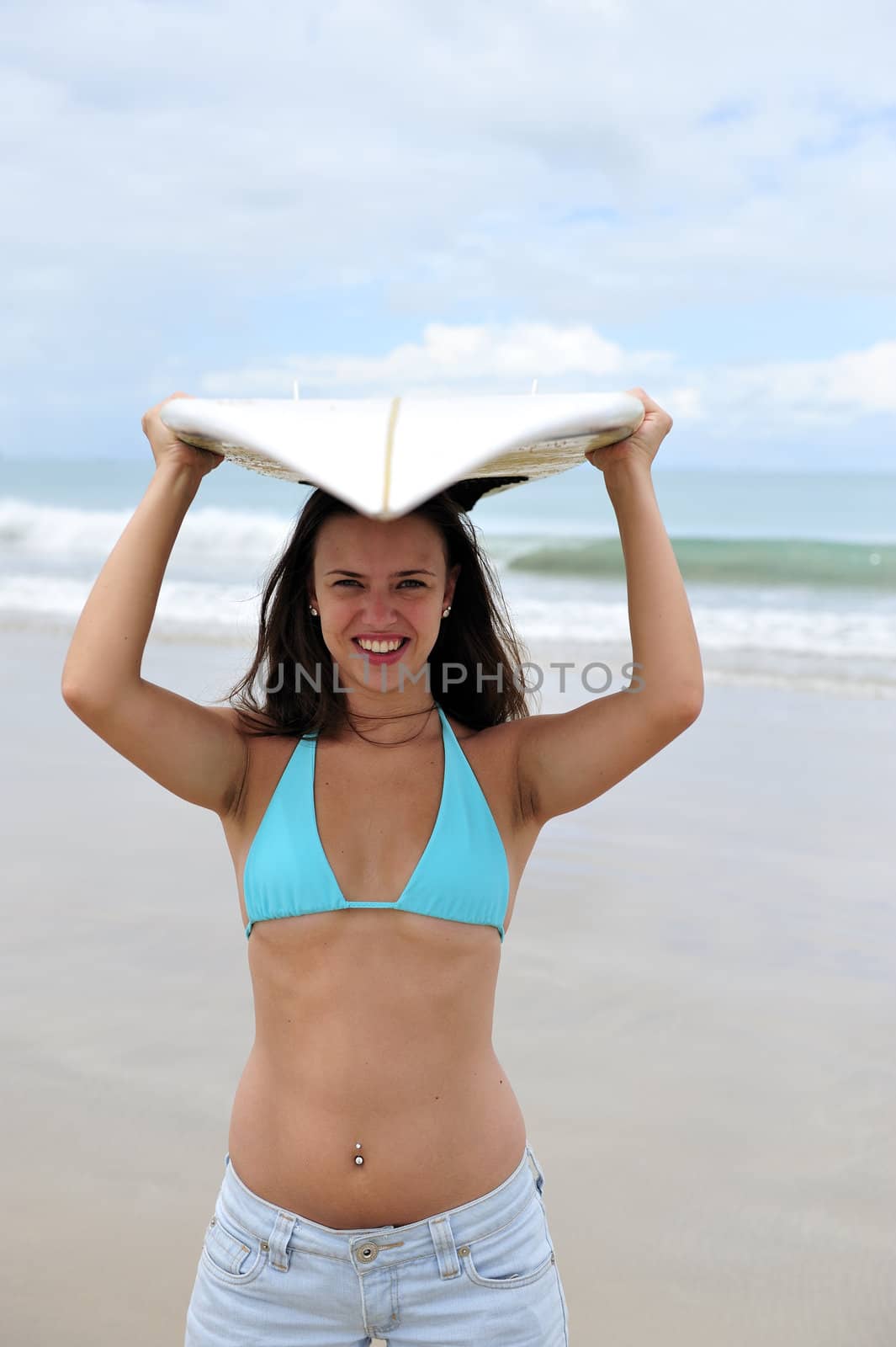 Surf girl holding a board in Brazil
