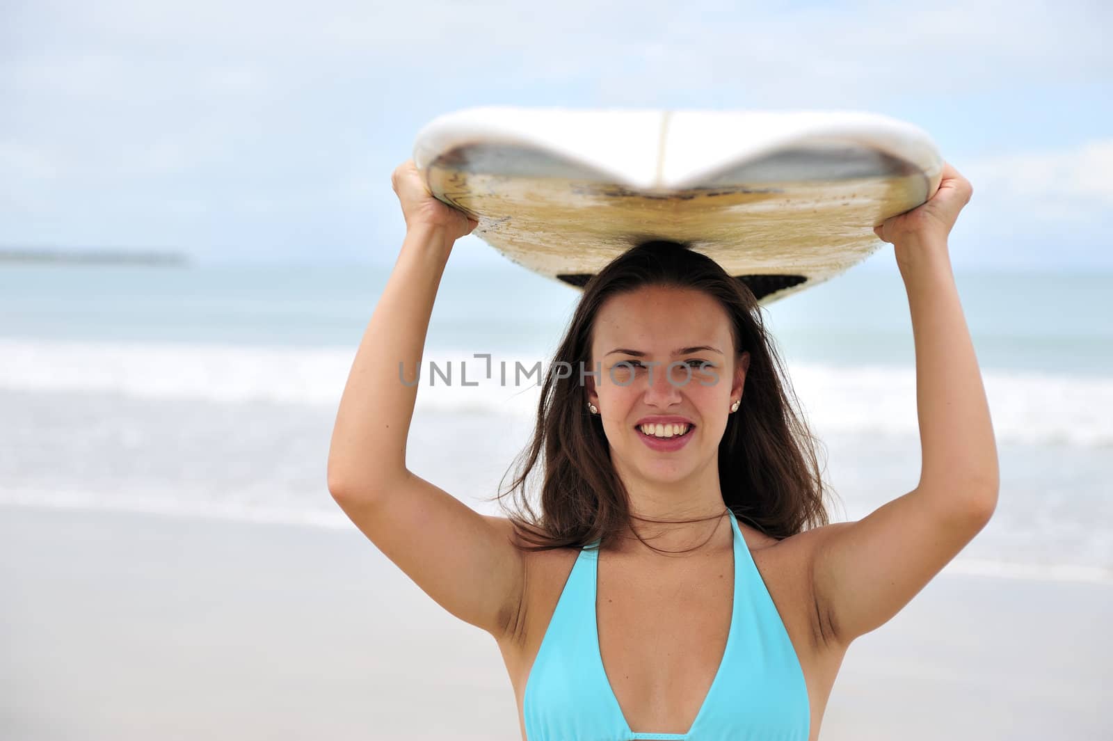 Surf girl holding a board in Brazil
