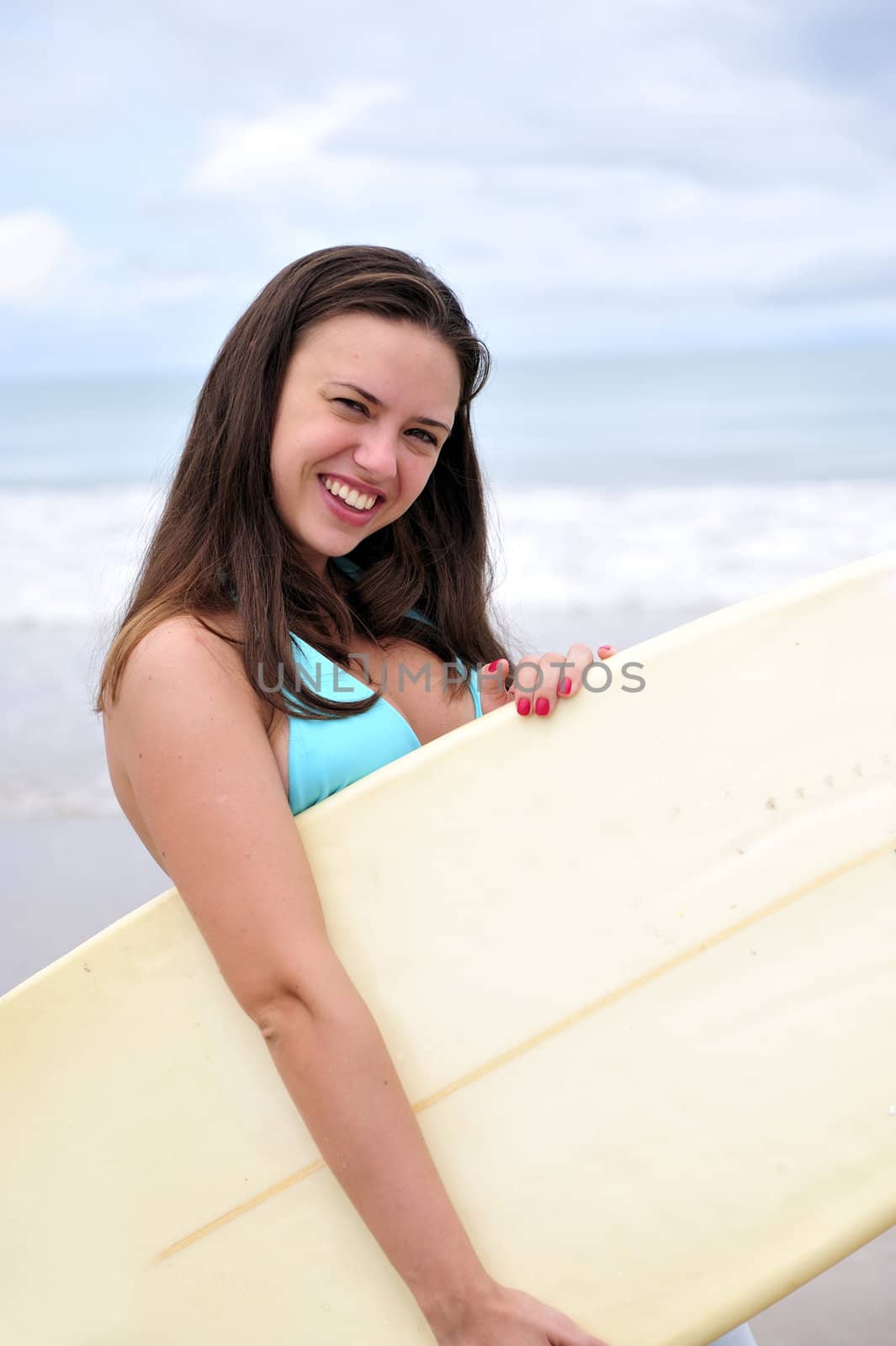 Surf girl holding a board in Brazil
