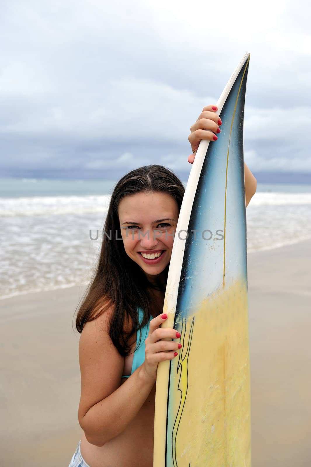 Surf girl holding a board in Brazil
