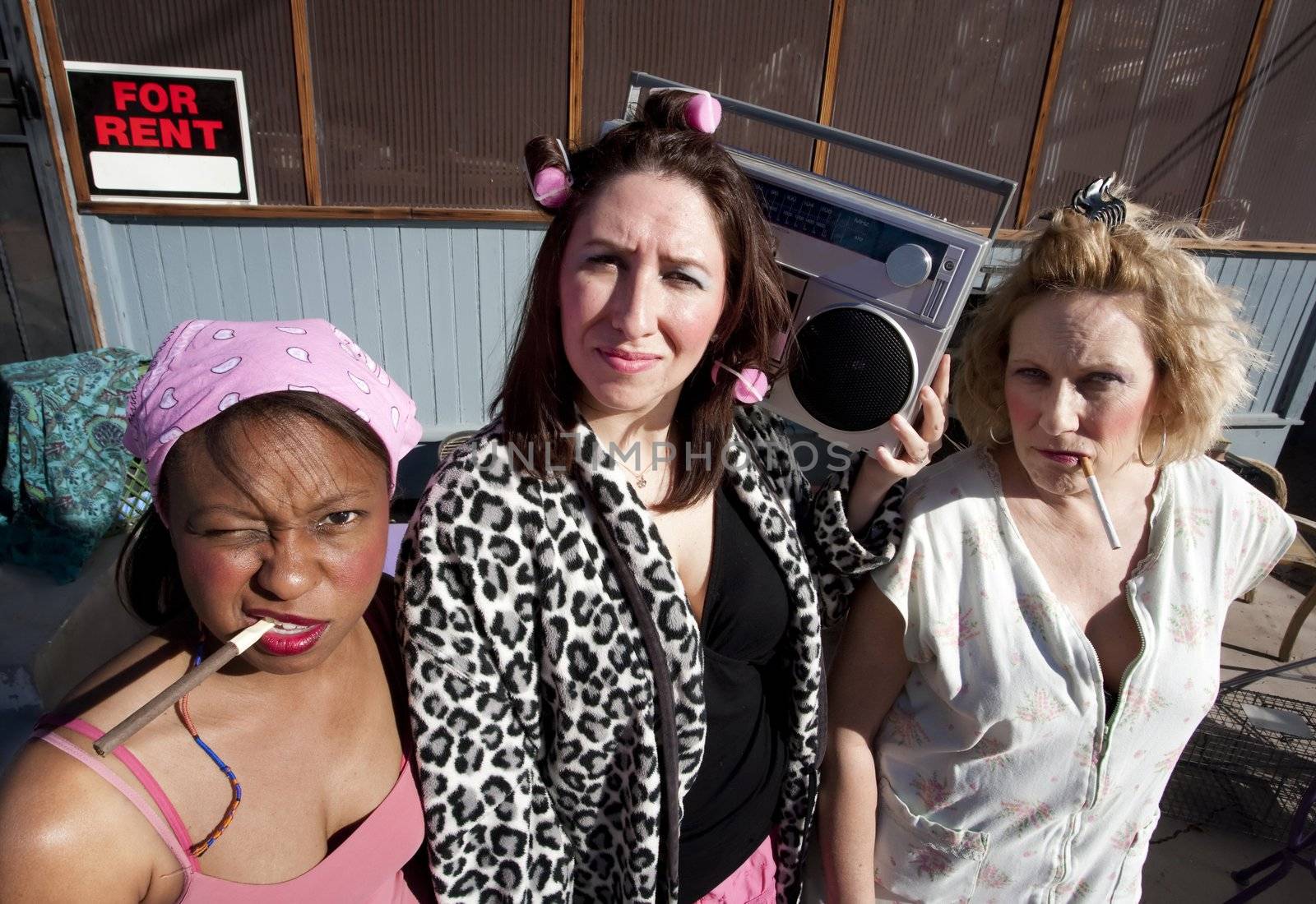 Portrait of three trashy women outdoors