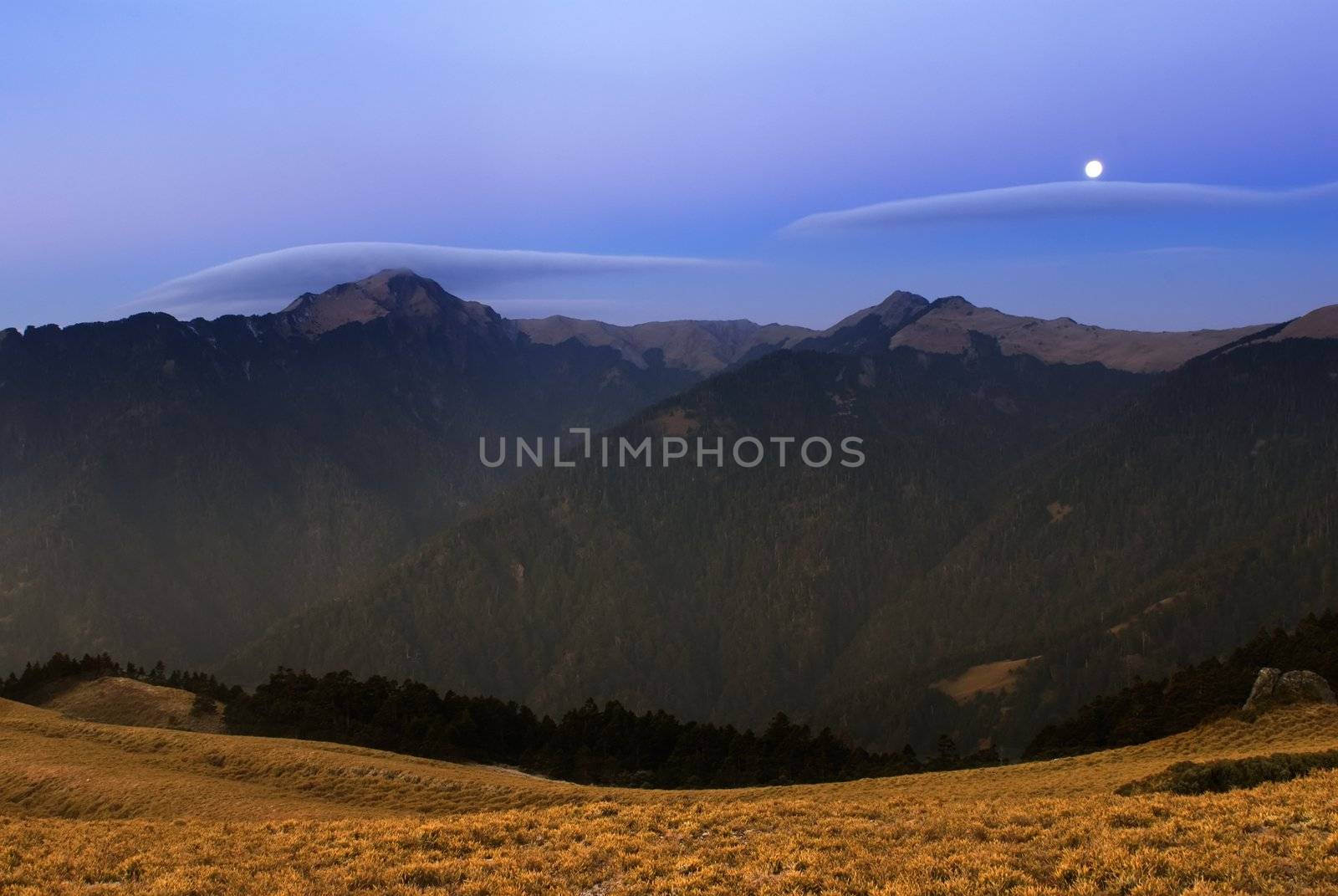 Moon rised and shining over the high mountain. by elwynn